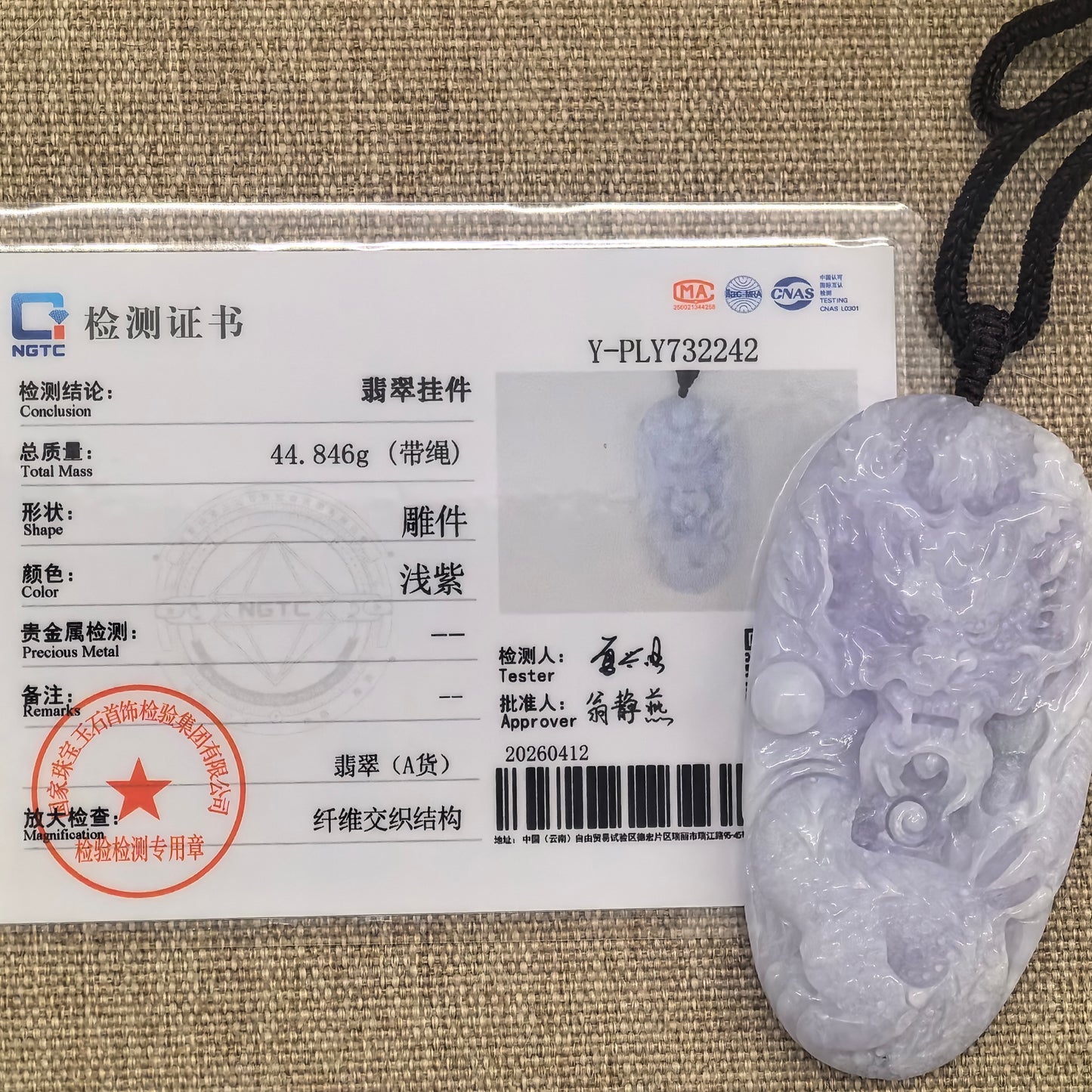 NGTC certified natural Grade-A light purple jadeite dragon pendant displayed with its matching certificate.