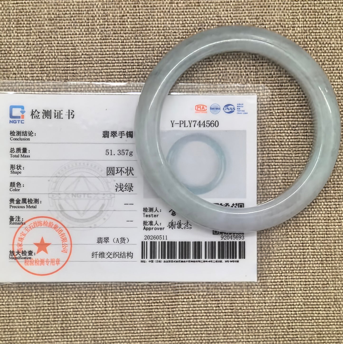 NGTC certified glutinous pale green D-shape jadeite bangle shown with matching certificate.