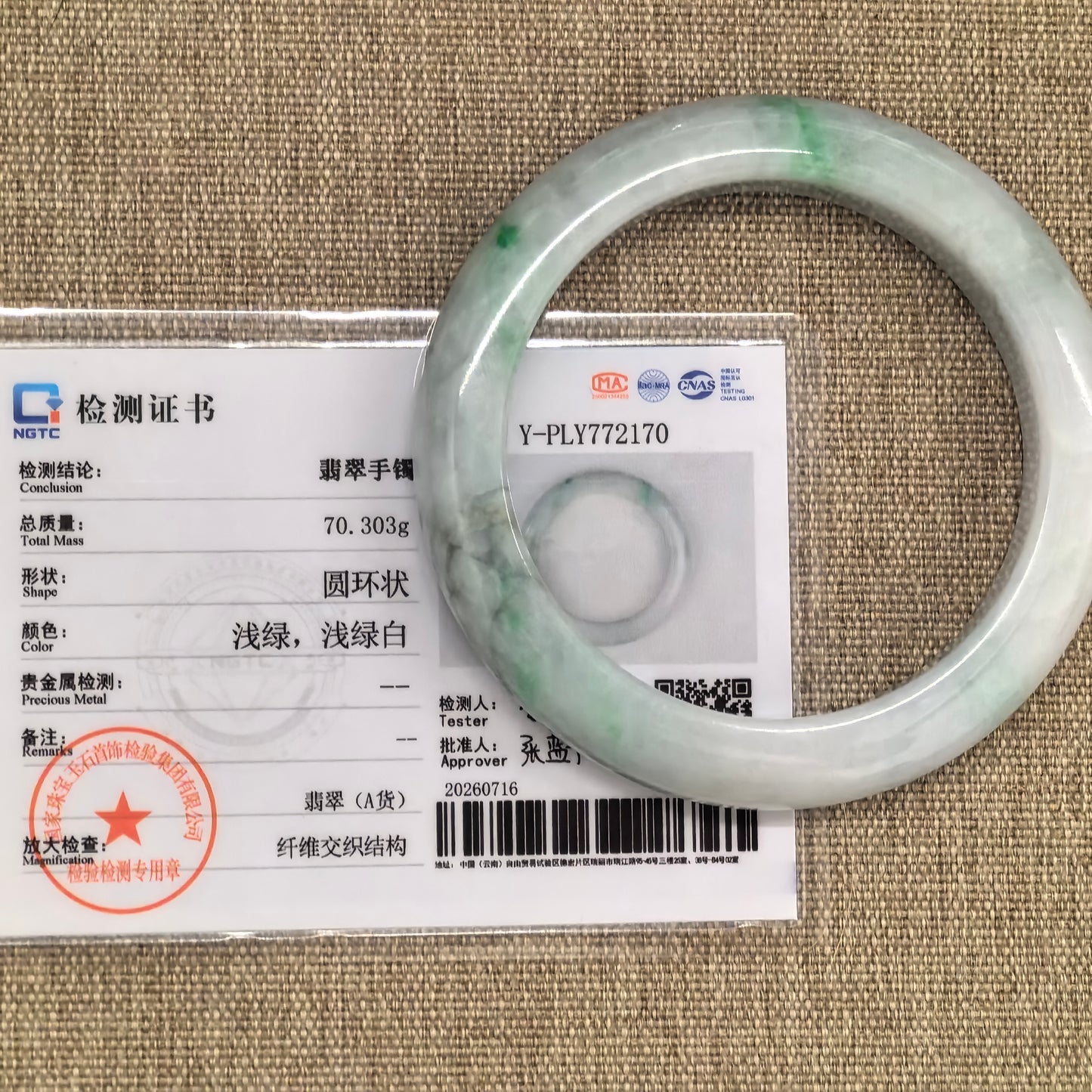 NGTC-certified natural Grade-A Burmese jadeite bangle displayed with its matching certificate.