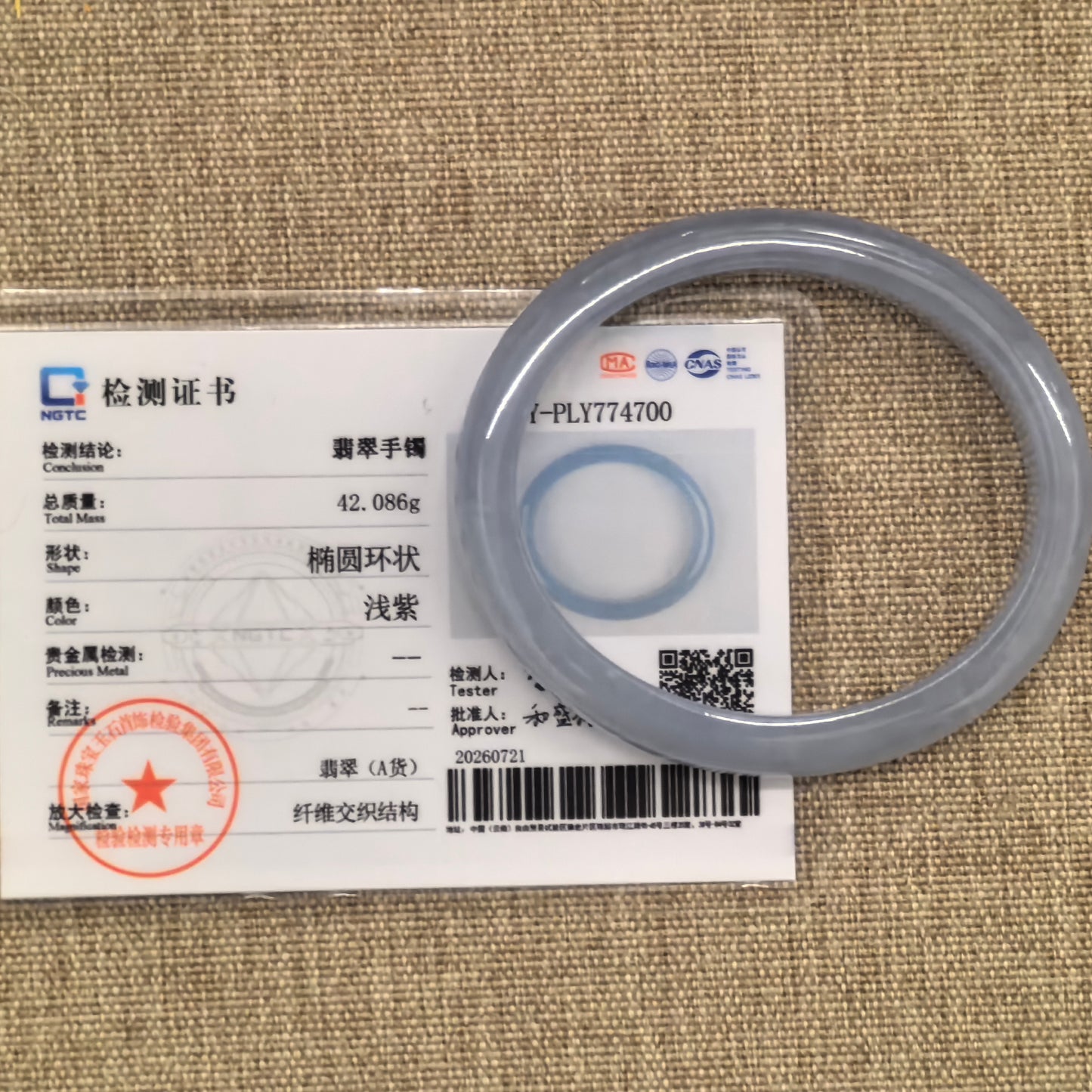 NGTC-certified blue-lavender Burmese jadeite oval bangle displayed with its matching certificate.