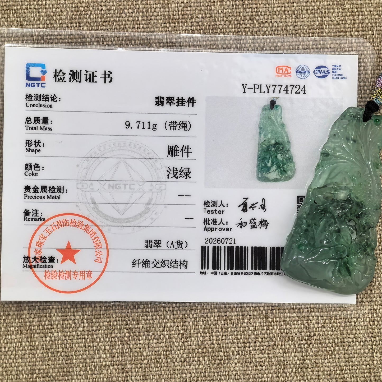 NGTC-certified natural Grade-A Burmese jadeite lotus and fish pendant shown with its matching certificate.