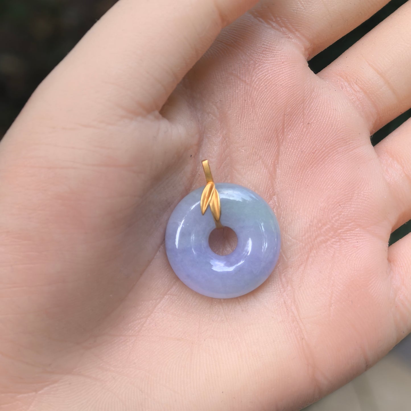 Natural Grade-A glutinous purple donut jadeite pendant with 18K gold leaf-style bail shown on hand.

