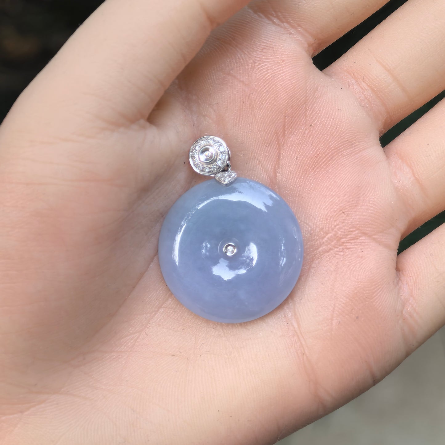 Natural Grade-A fine glutinous purple Peace Pendant jadeite pendant with 18K gold and diamond accents shown on hand.

