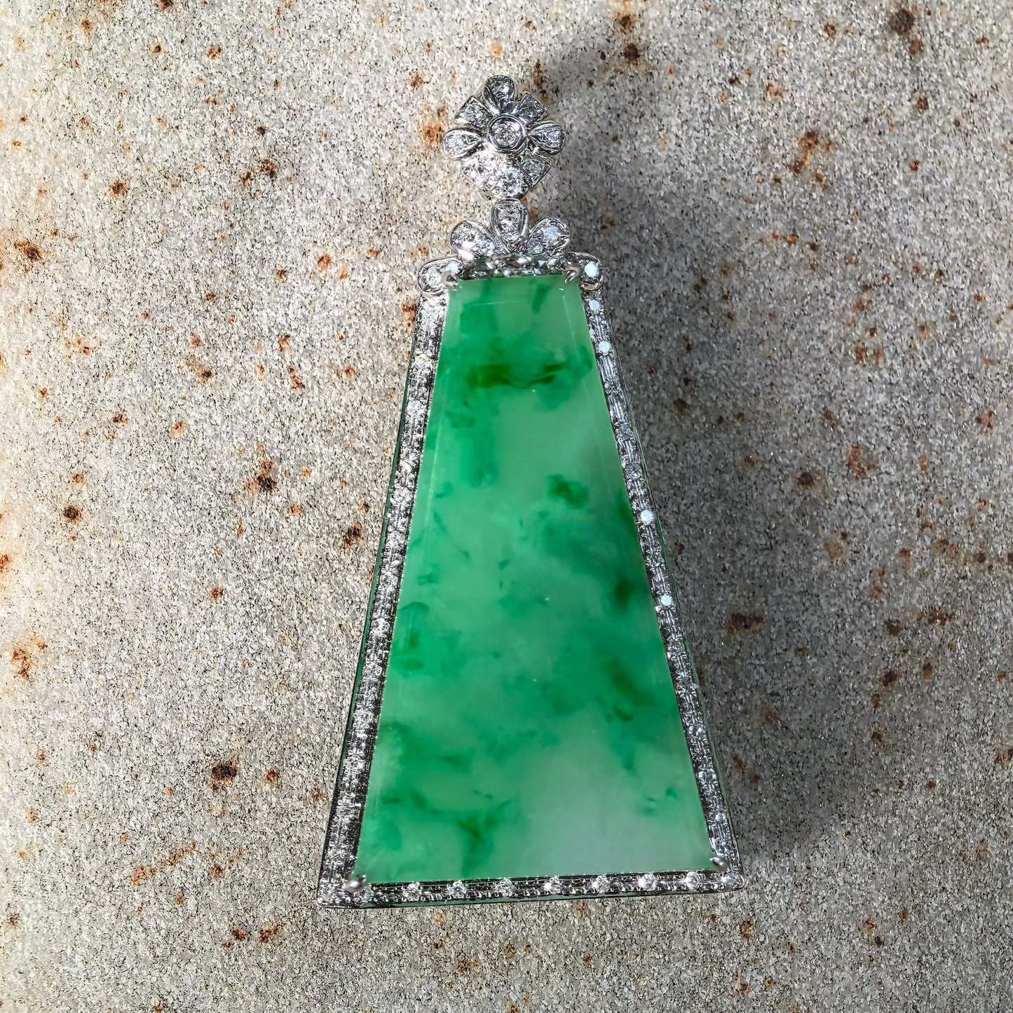 Natural Grade-A green floating flower Plain Jade Plaque pendant on stone background with bright jadeite color.
