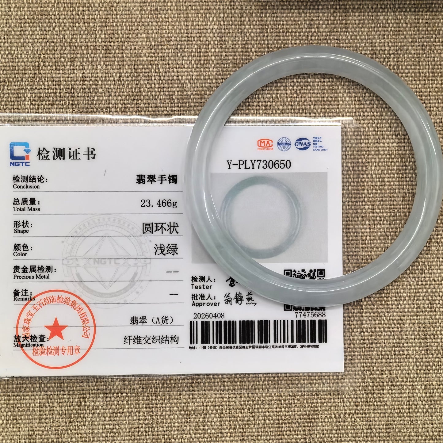 NGTC certified Natural Grade-A light green jadeite round bangle shown with matching certificate and 23.466 g weight.