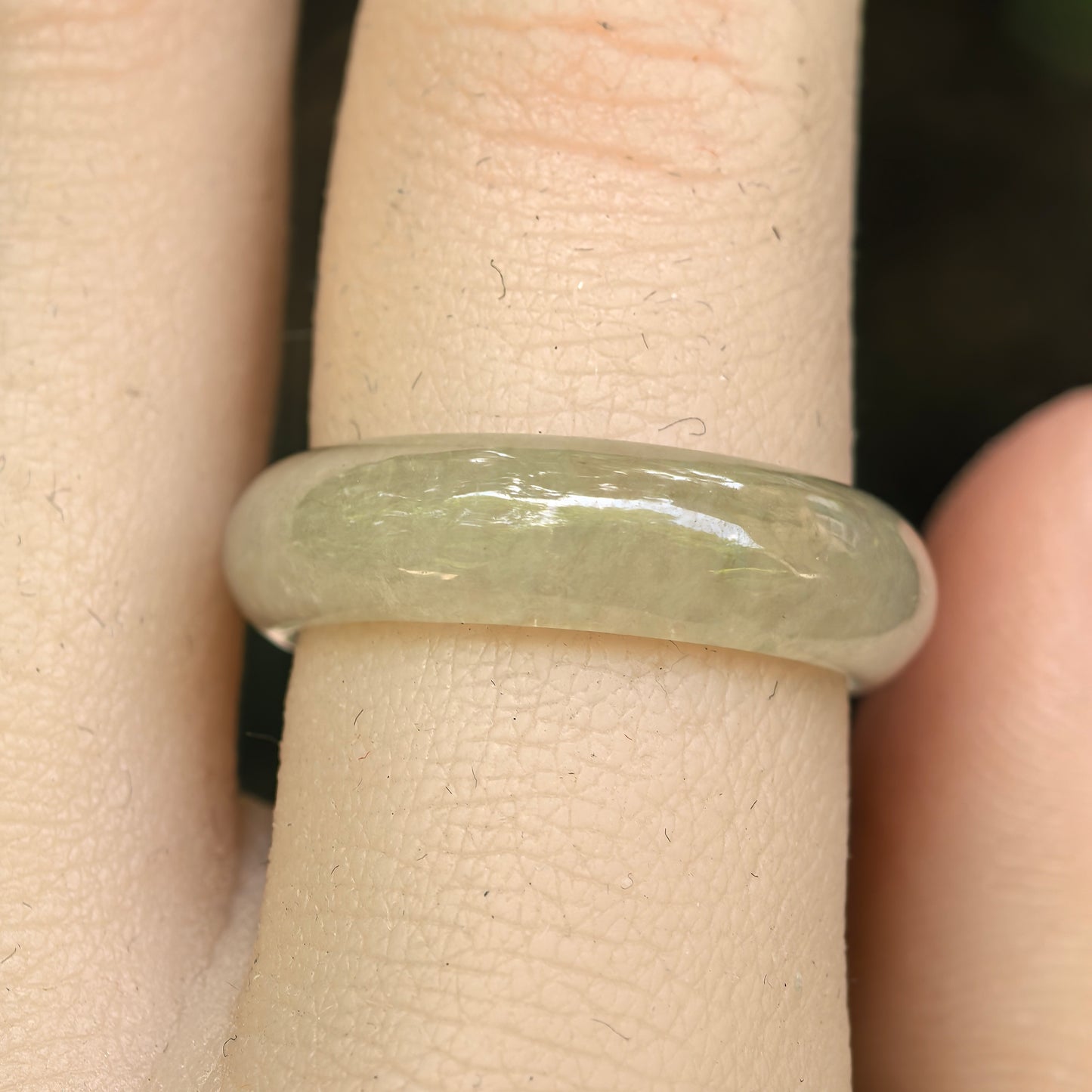 Close-up side view of yellow jadeite ring band with rounded profile and smooth luster.

