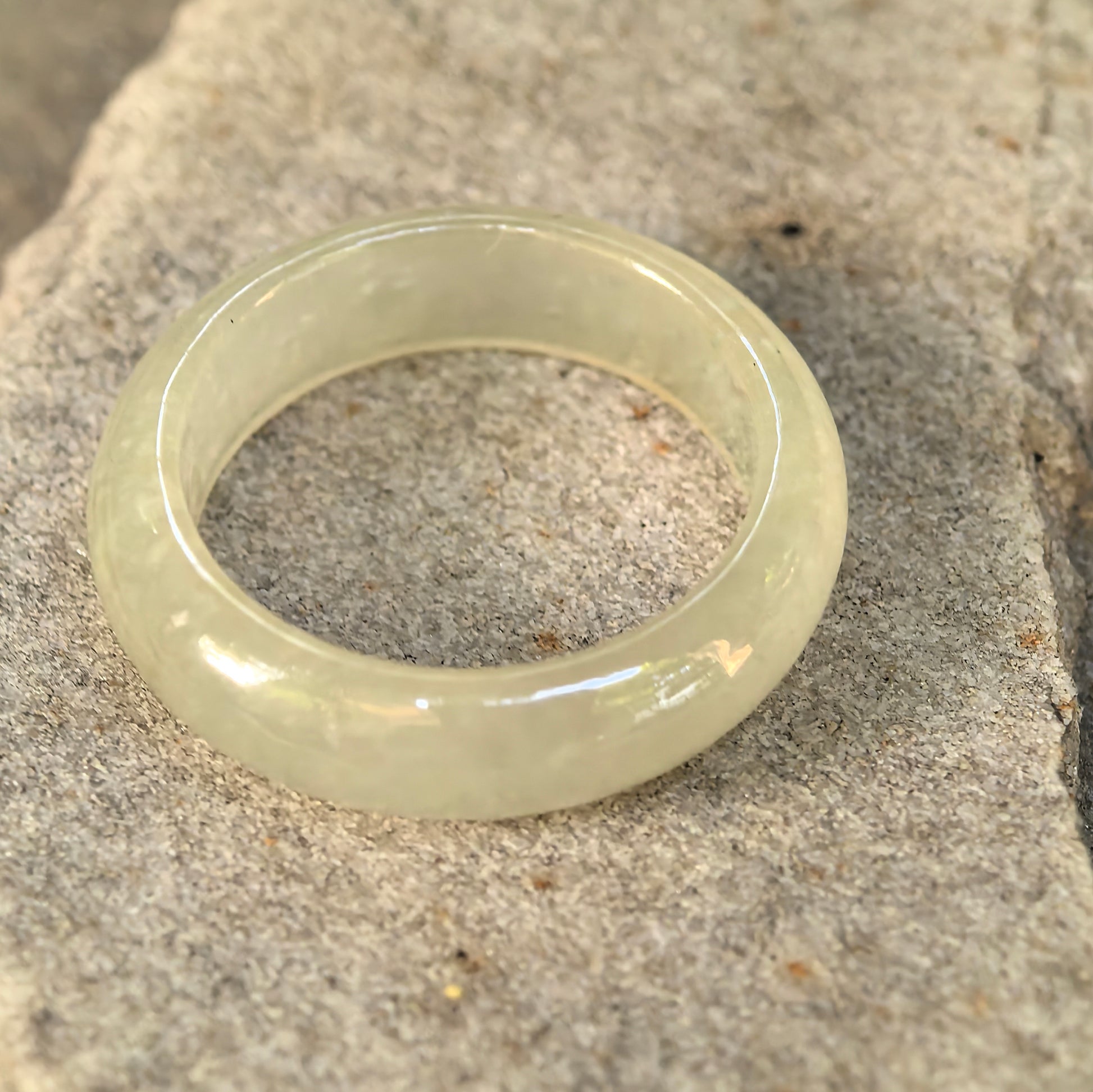 Detailed view of icy yellow Burmese jadeite ring band with soft natural internal texture.
