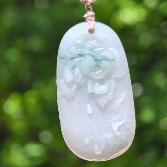 Natural Grade-A glutinous floating green carved jadeite pendant hanging on cord, front view.
