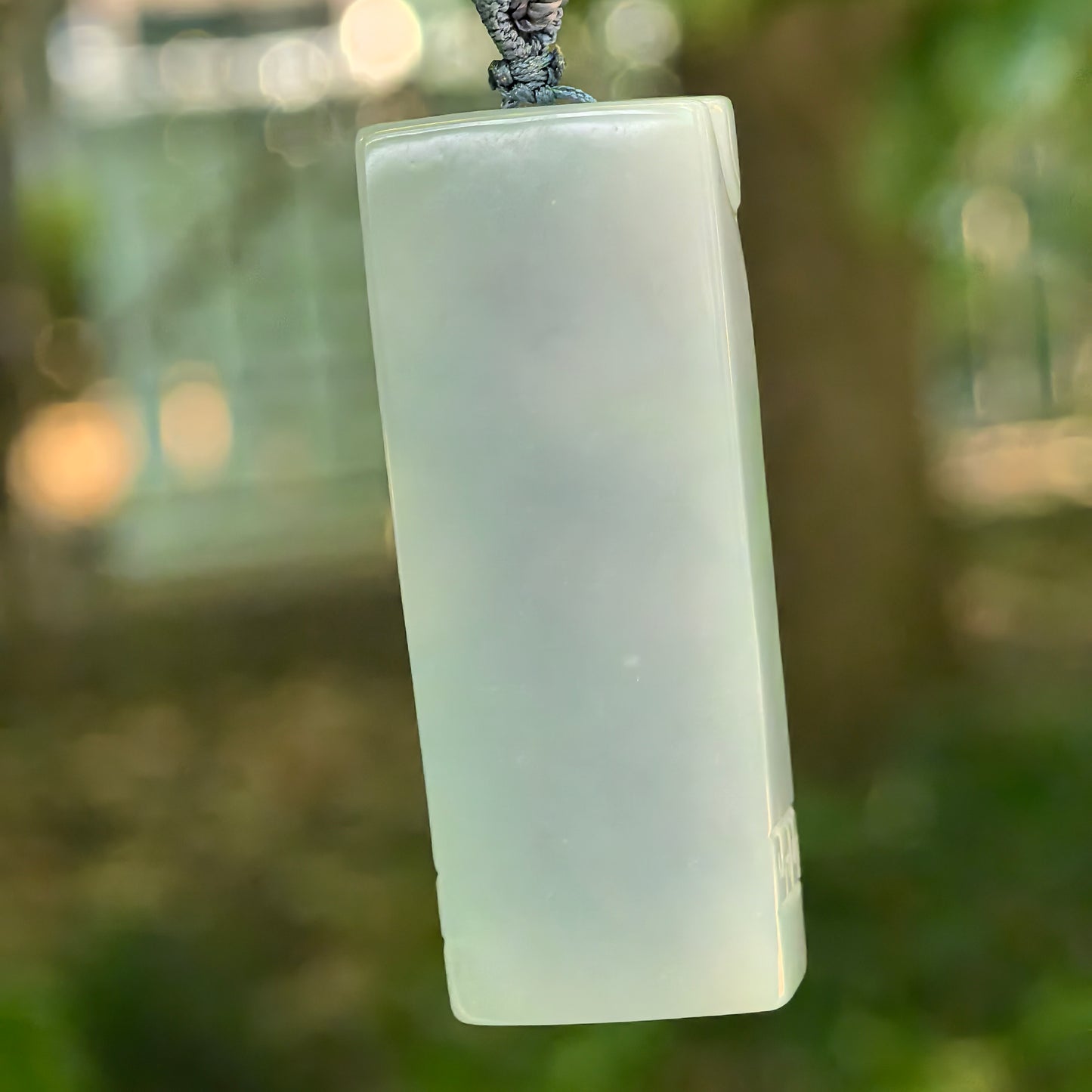 Back view of natural Grade-A blue-lavender jadeite pendant with clean rectangular form and soft glutinous texture.