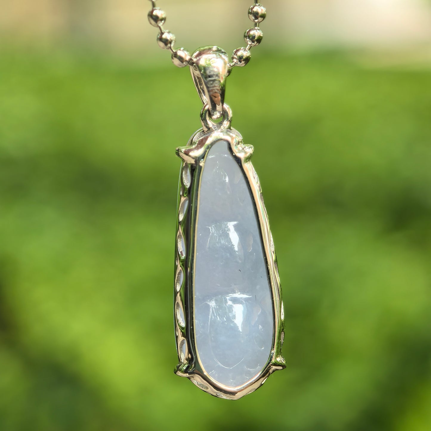 Back view of petite violet bean jadeite pendant showing 18K gold setting and soft translucent jadeite body.