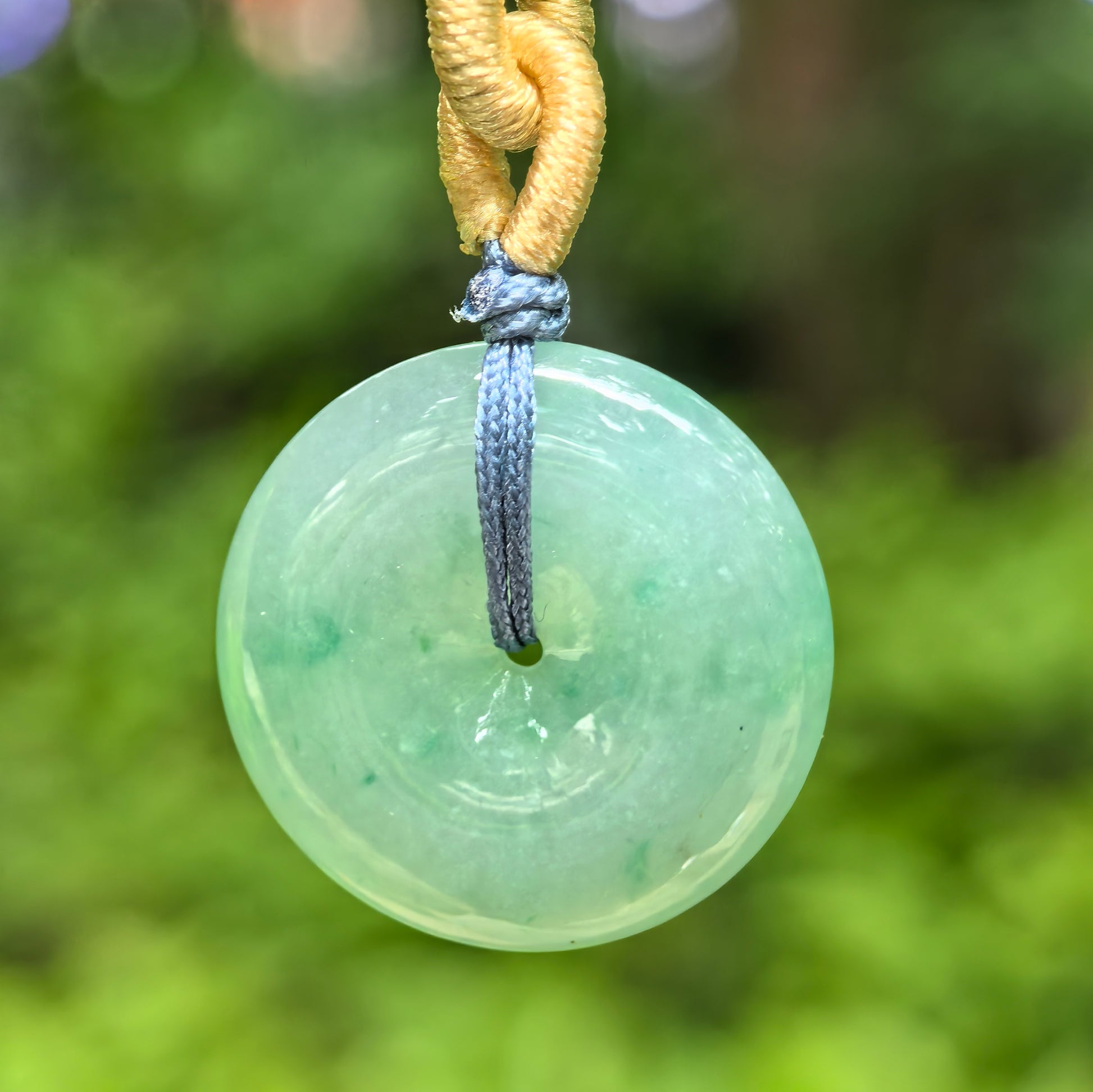 Natural Grade-A glutinous green Peace Pendant jadeite pendant hanging outdoors with cord.