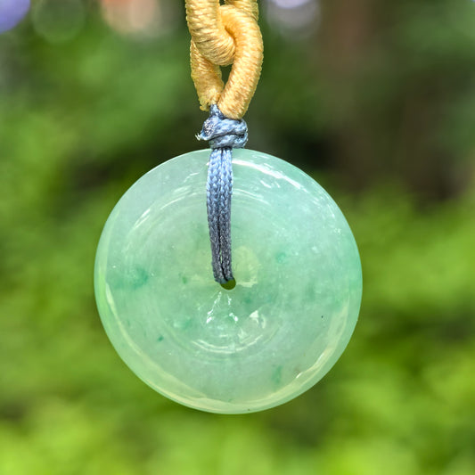 Natural Grade-A glutinous green Peace Pendant jadeite pendant hanging outdoors with cord.