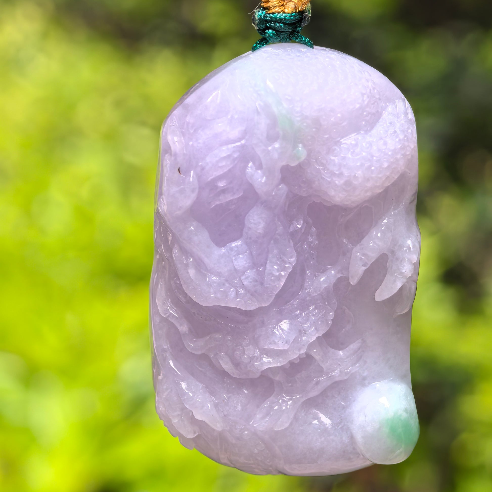 Natural Grade-A glutinous light purple jadeite dragon pendant with pale green accent shown from the front.