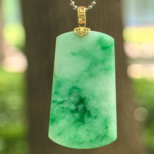 Natural Grade-A glutinous light green plain jade plaque pendant with floating green patterns and 18K gold bail.
