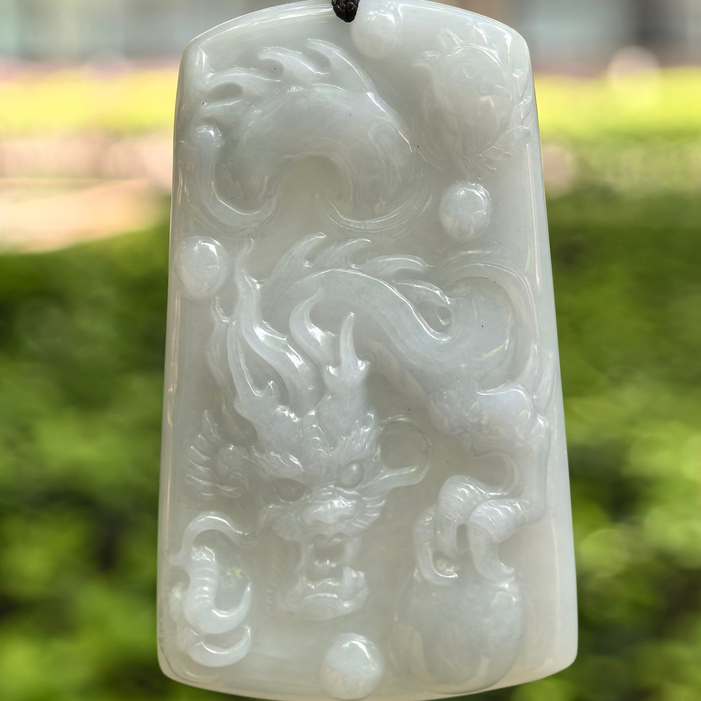 Natural Grade-A fine glutinous blue base dragon jadeite plaque pendant with raised dragon carving.
