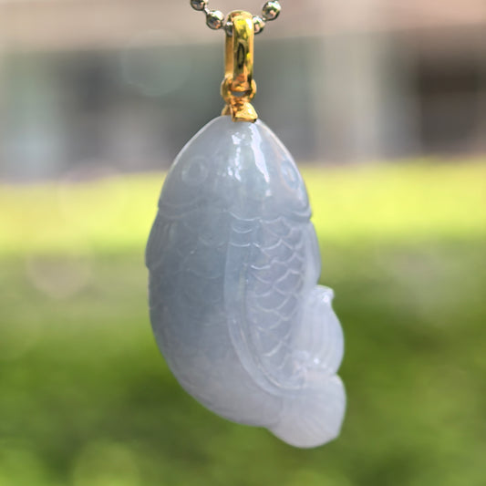 Natural Grade-A glutinous lavender fish jadeite pendant with 18K gold bail hanging on chain.
