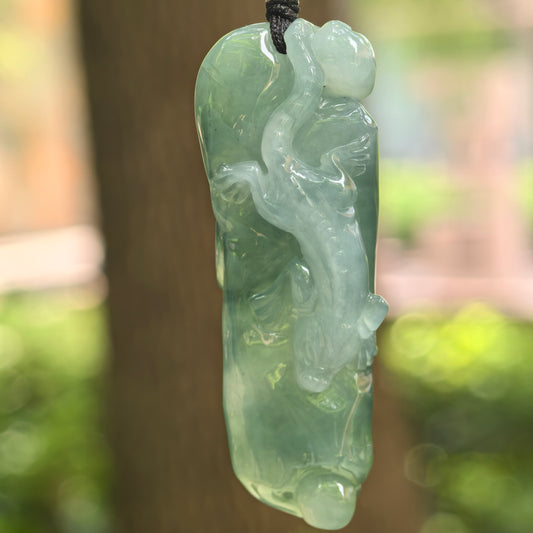 Natural Grade-A icy glutinous oil green chi-dragon jadeite pendant hanging on cord.
