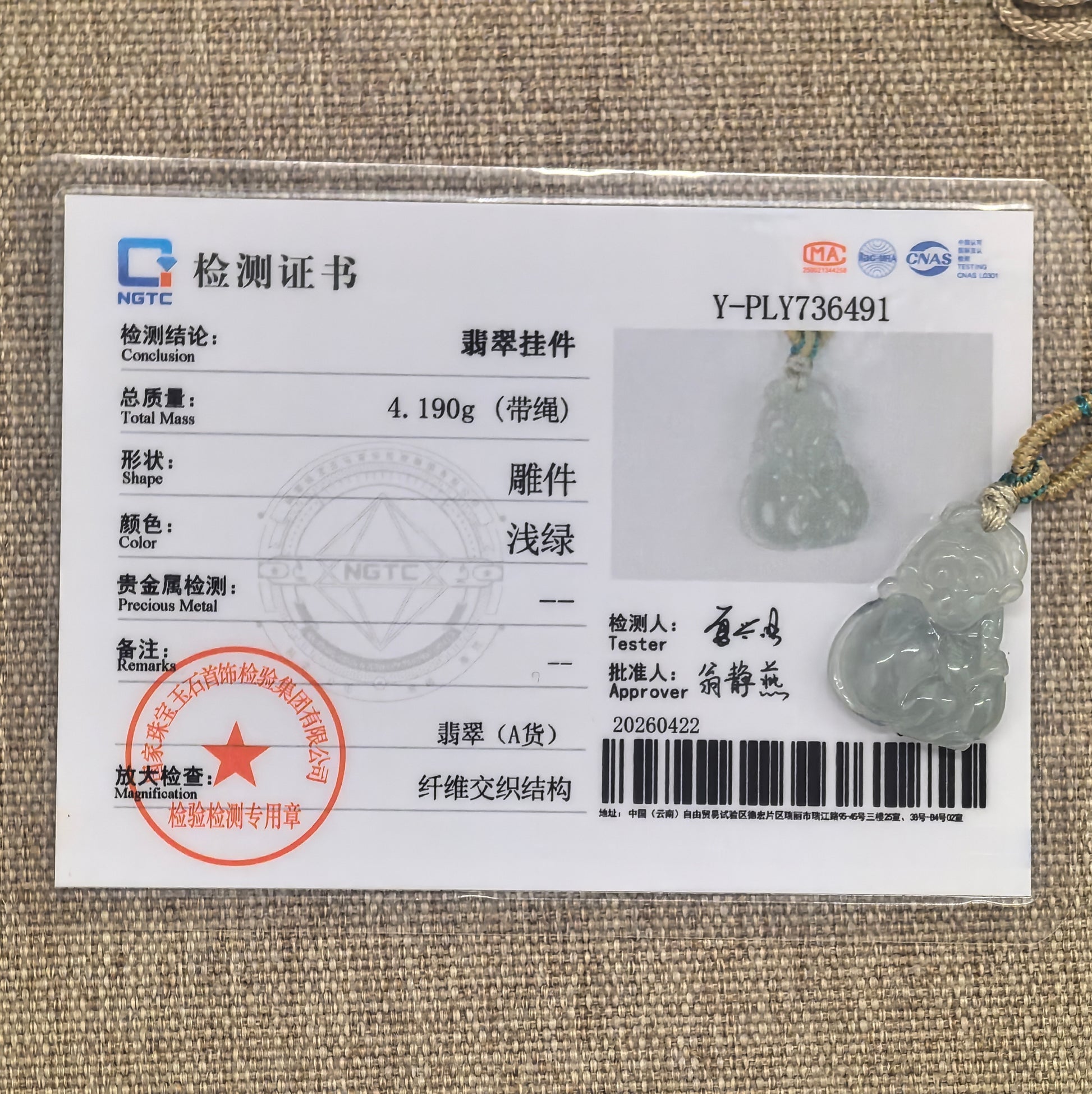 NGTC certified light green monkey jadeite pendant shown with matching certificate and cord.