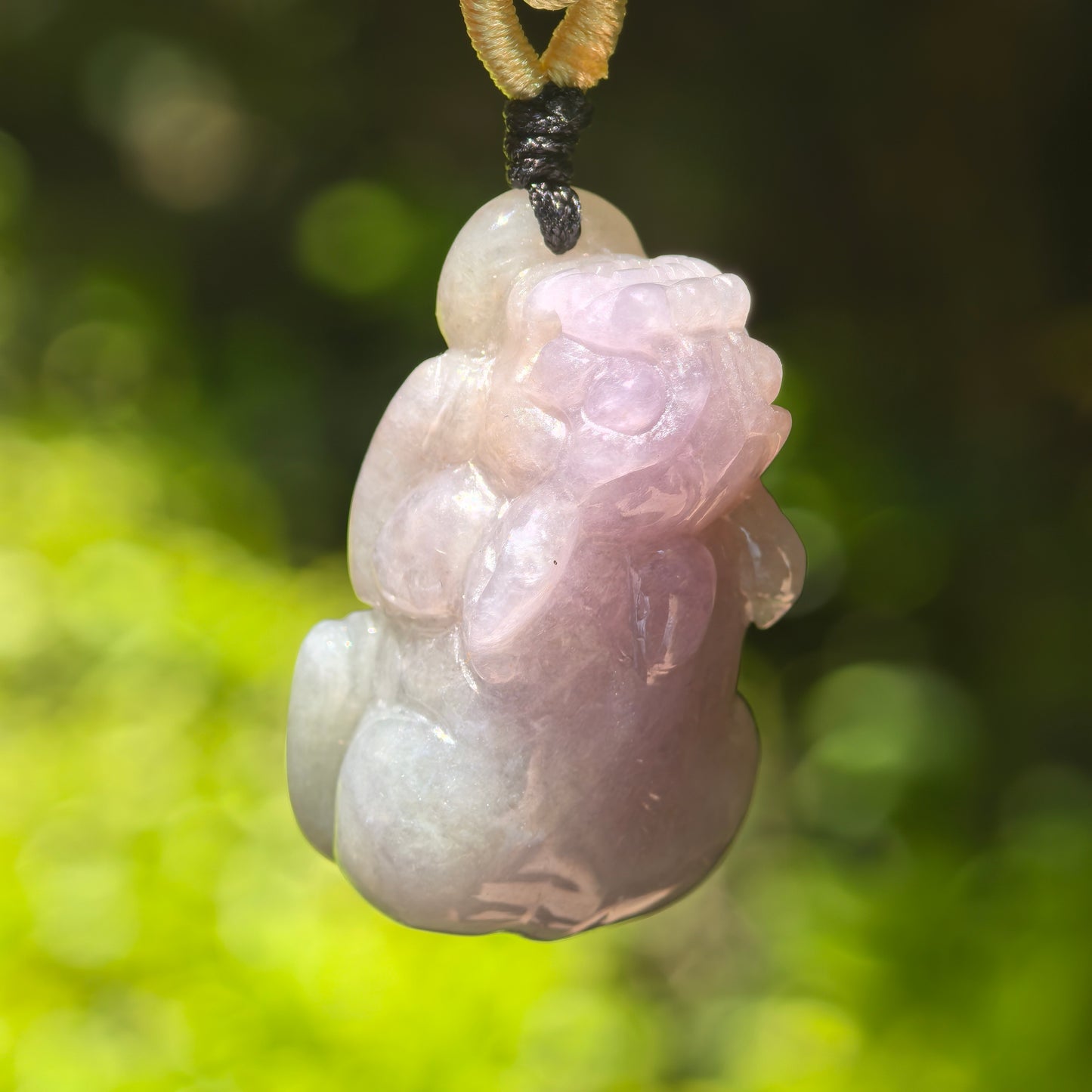 Close-up of lavender purple Pixiu jadeite pendant showing rounded three-dimensional carving.
