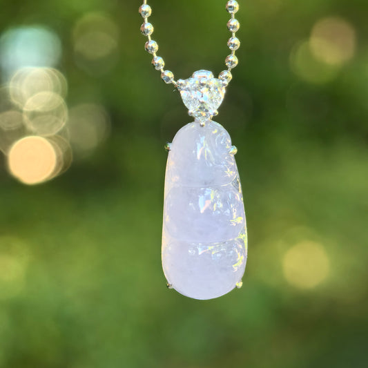 Close-up of 18K gold jadeite bean pod pendant with synthetic diamond accent.
