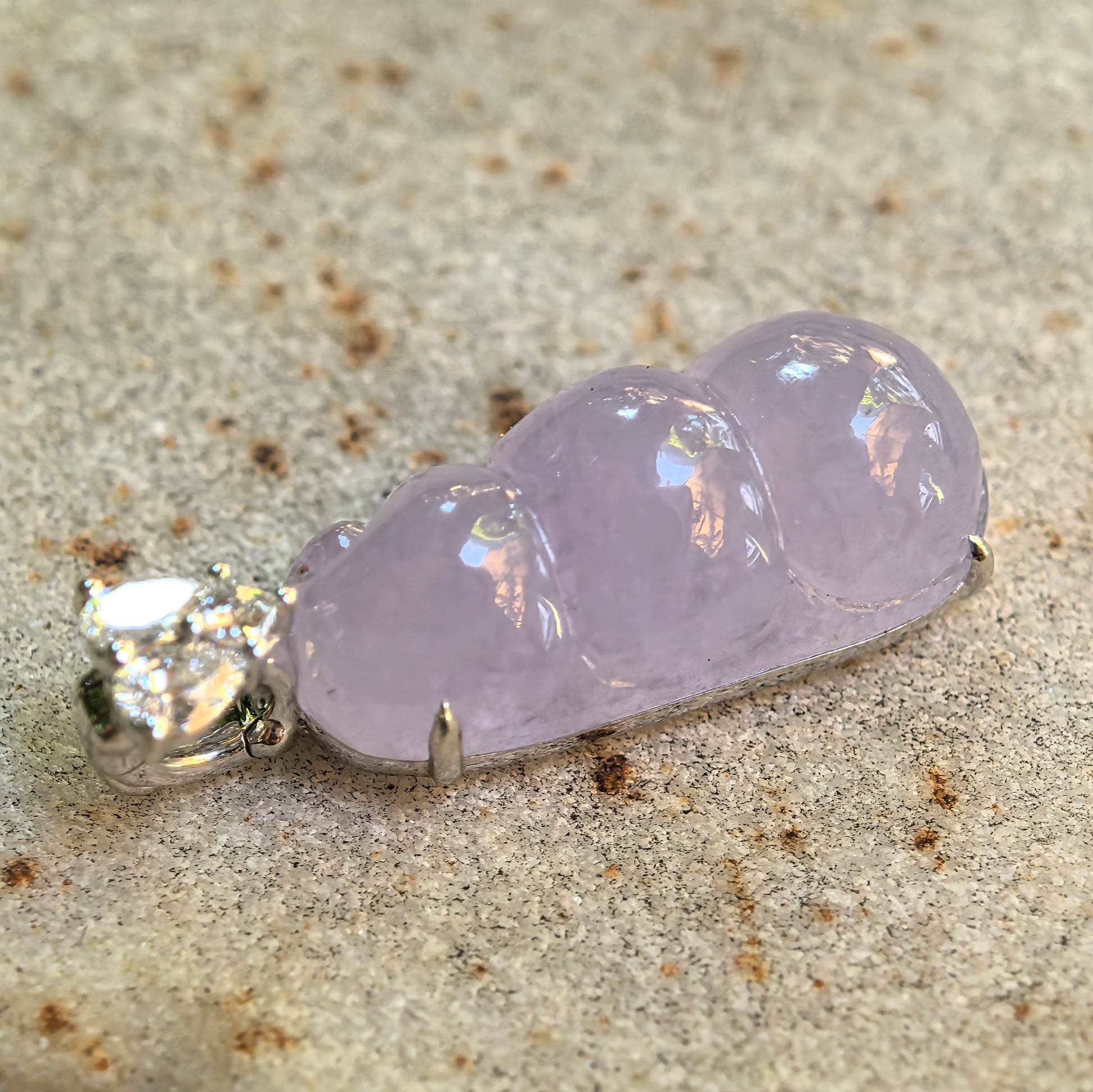 Natural Grade-A lavender bean pod jadeite pendant showing polished carving and soft translucency.