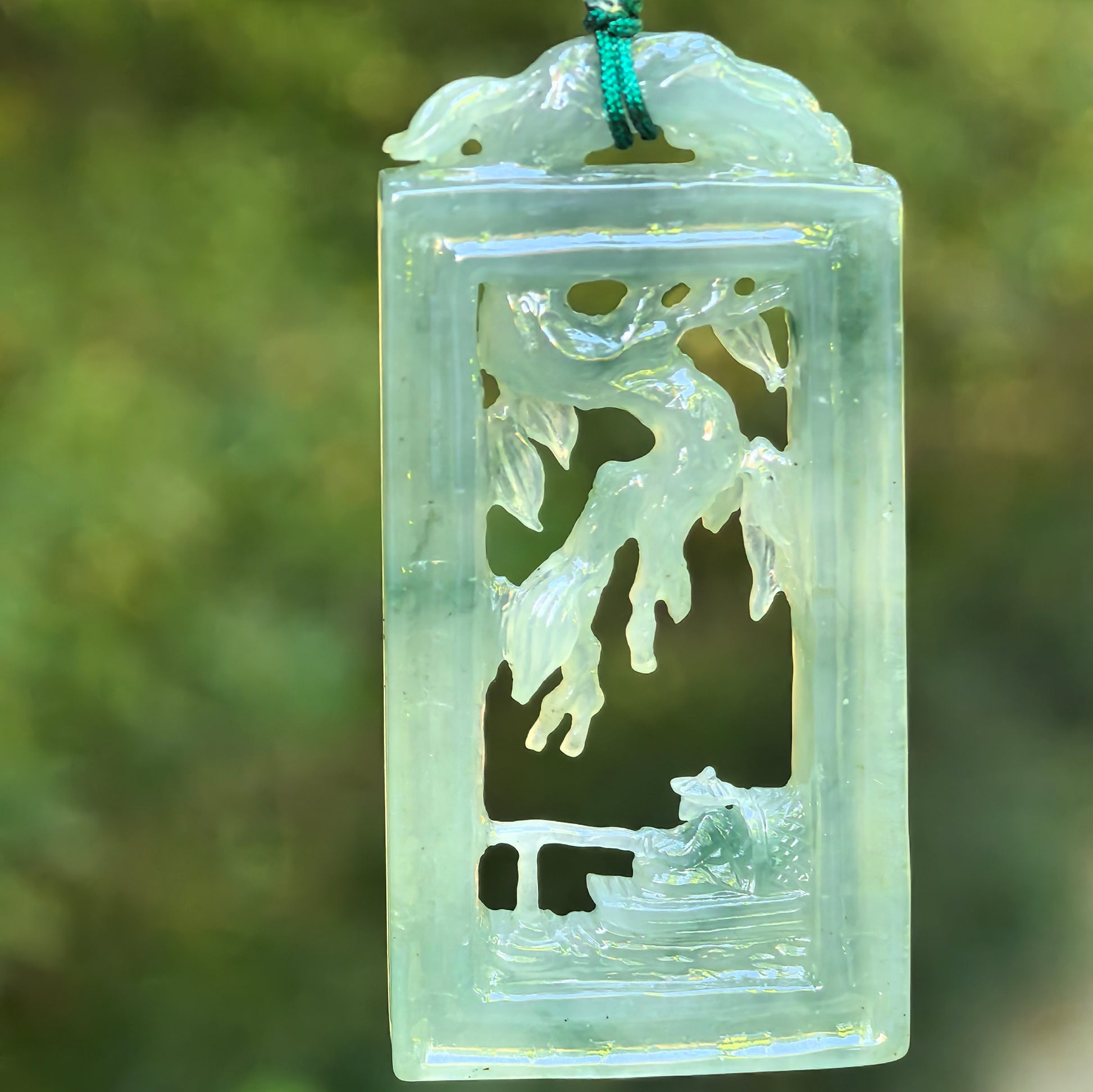Natural Grade-A icy glutinous pale green Solitary Fishing jadeite plaque pendant hanging on cord.
