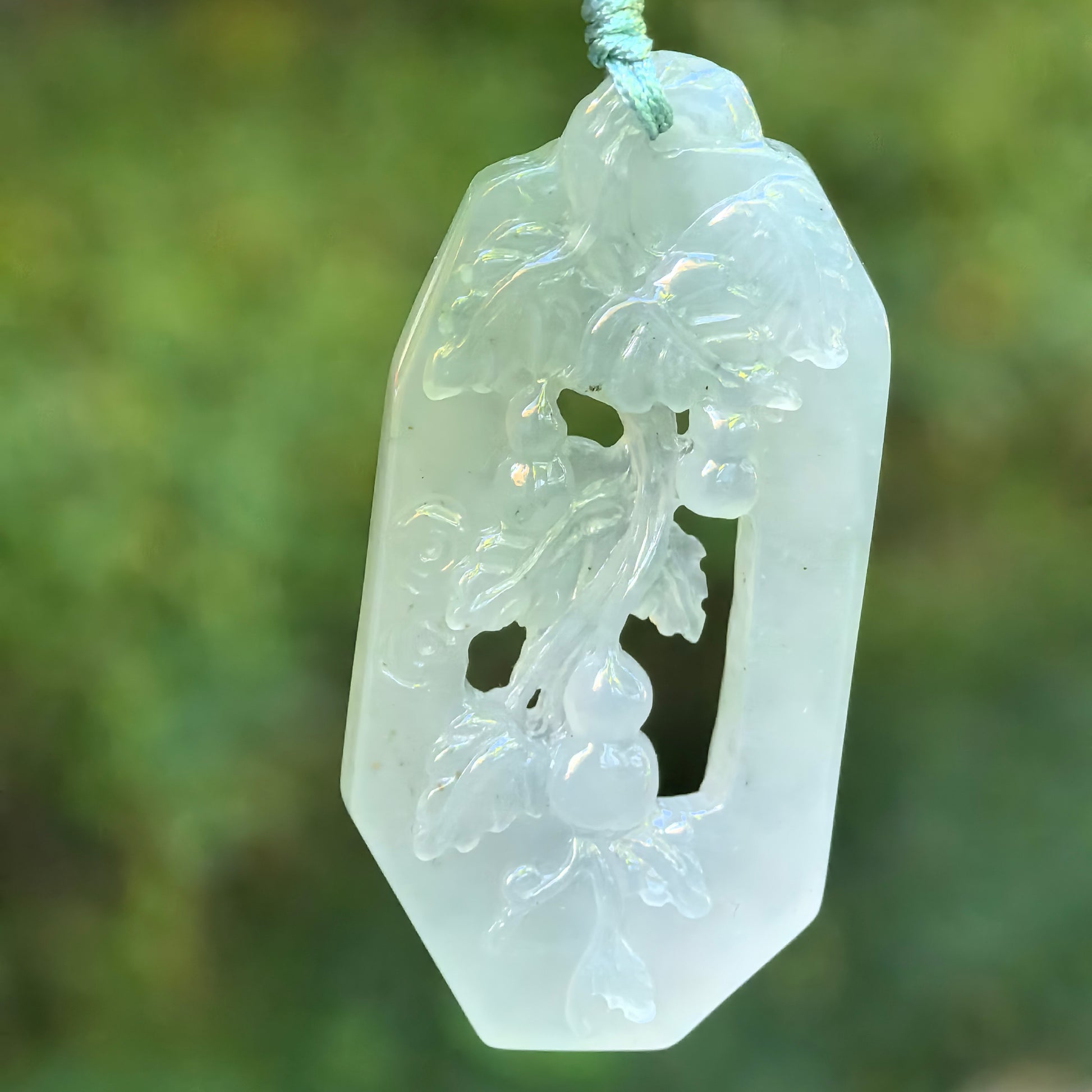 Natural Grade-A icy glutinous pale green openwork gourd vine jadeite pendant hanging on cord.

