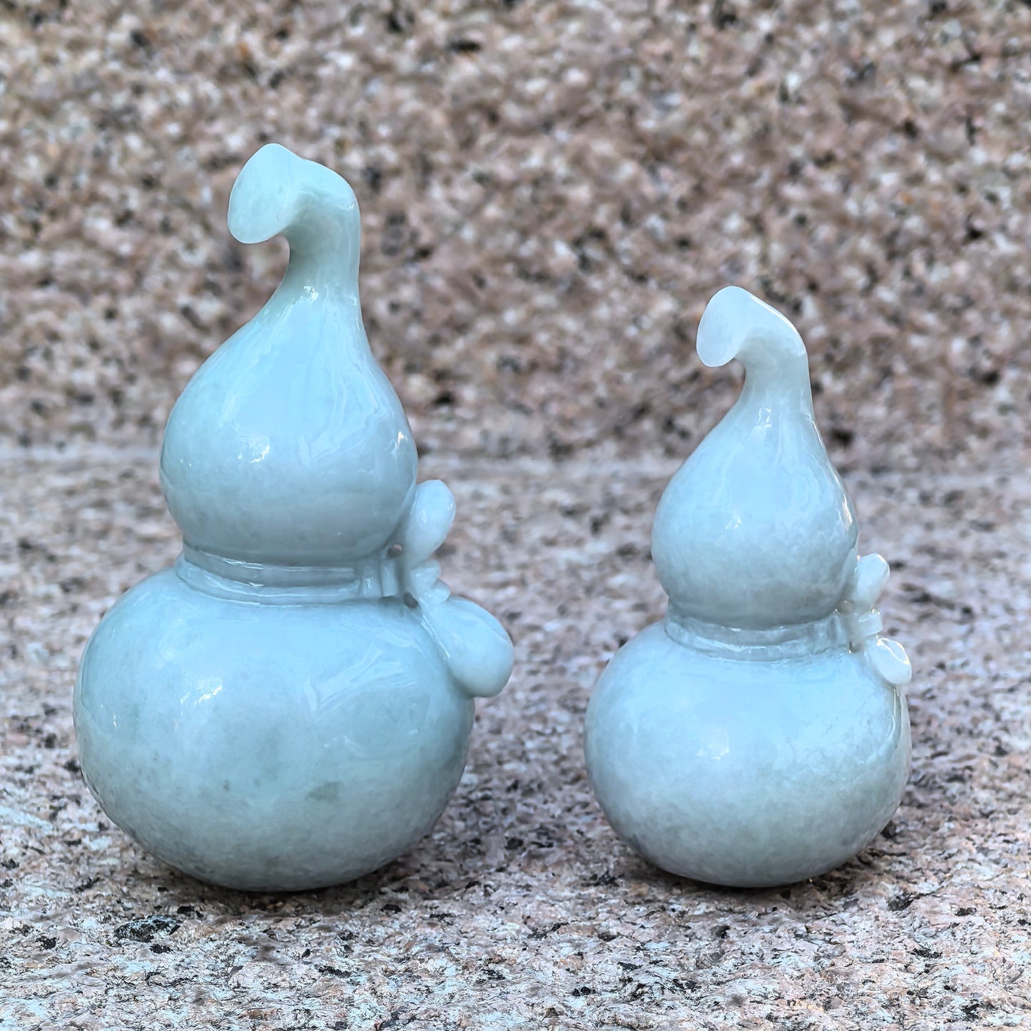 Large and small natural Grade-A jadeite gourd ornaments displayed together.
