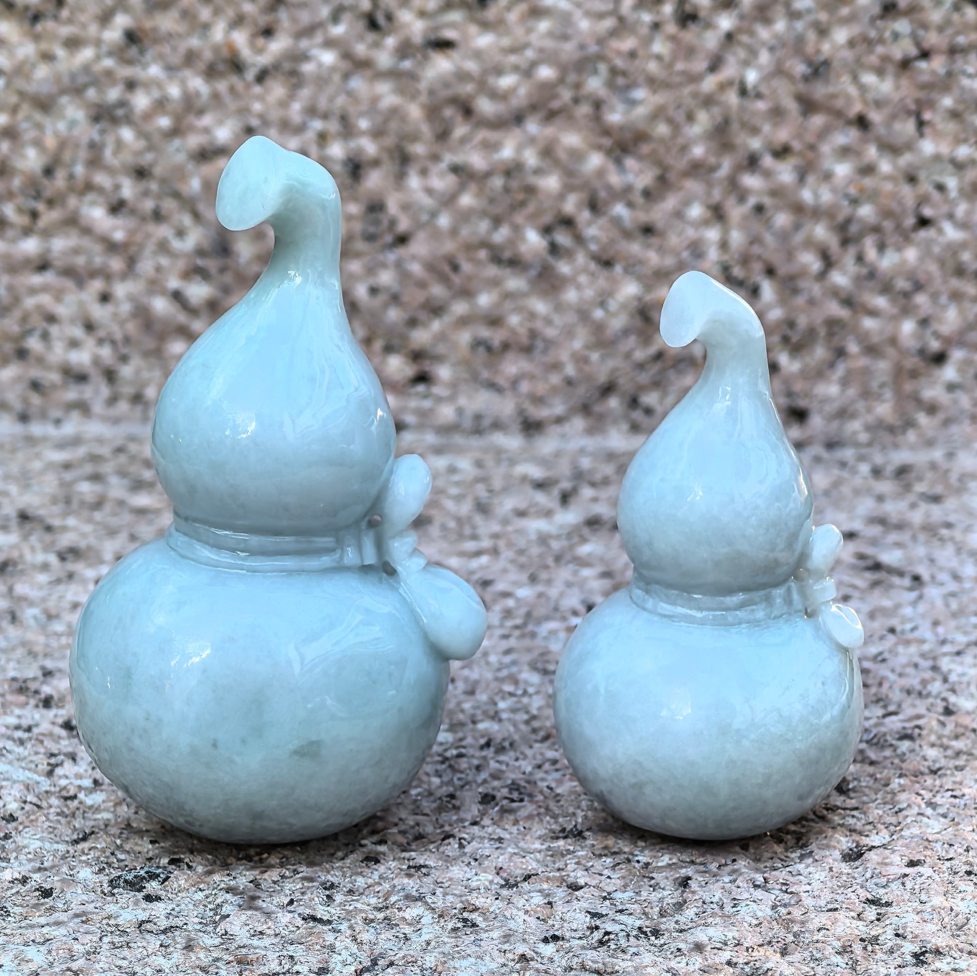Large and small natural Grade-A jadeite gourd ornaments displayed together.
