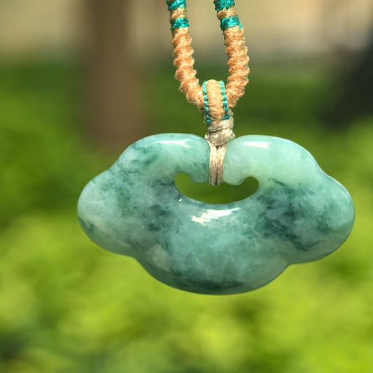 Natural Grade-A glutinous light green jadeite auspicious cloud pendant hanging on cord.
