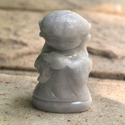 Natural Grade-A glutinous white and light green Chang'e jadeite ornament shown standing on stone.

