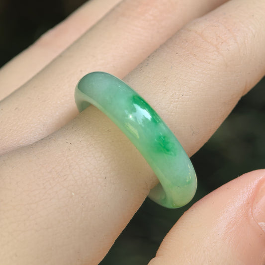 Natural Grade-A glutinous light green floating-flower jadeite ring band worn on finger.
