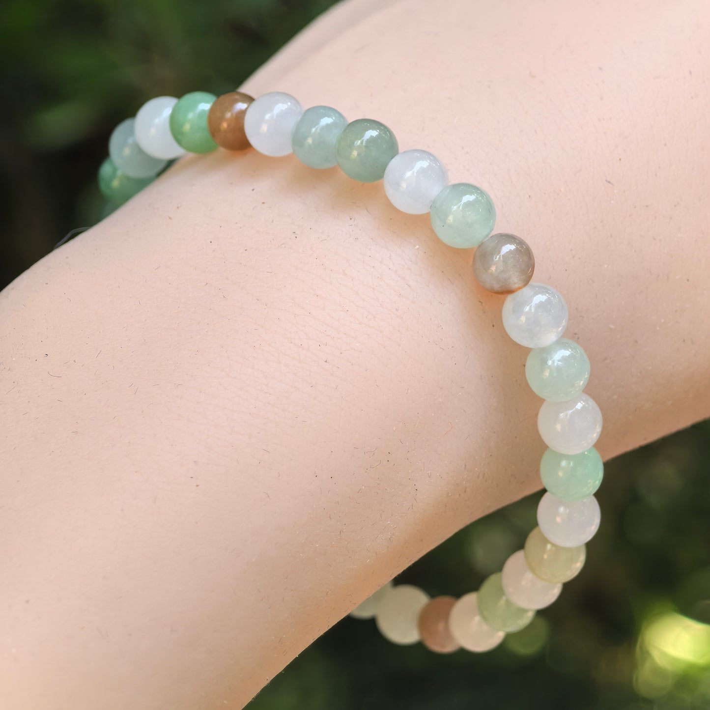 Natural Grade-A icy glutinous multicolor jadeite beaded bracelet worn on wrist.
