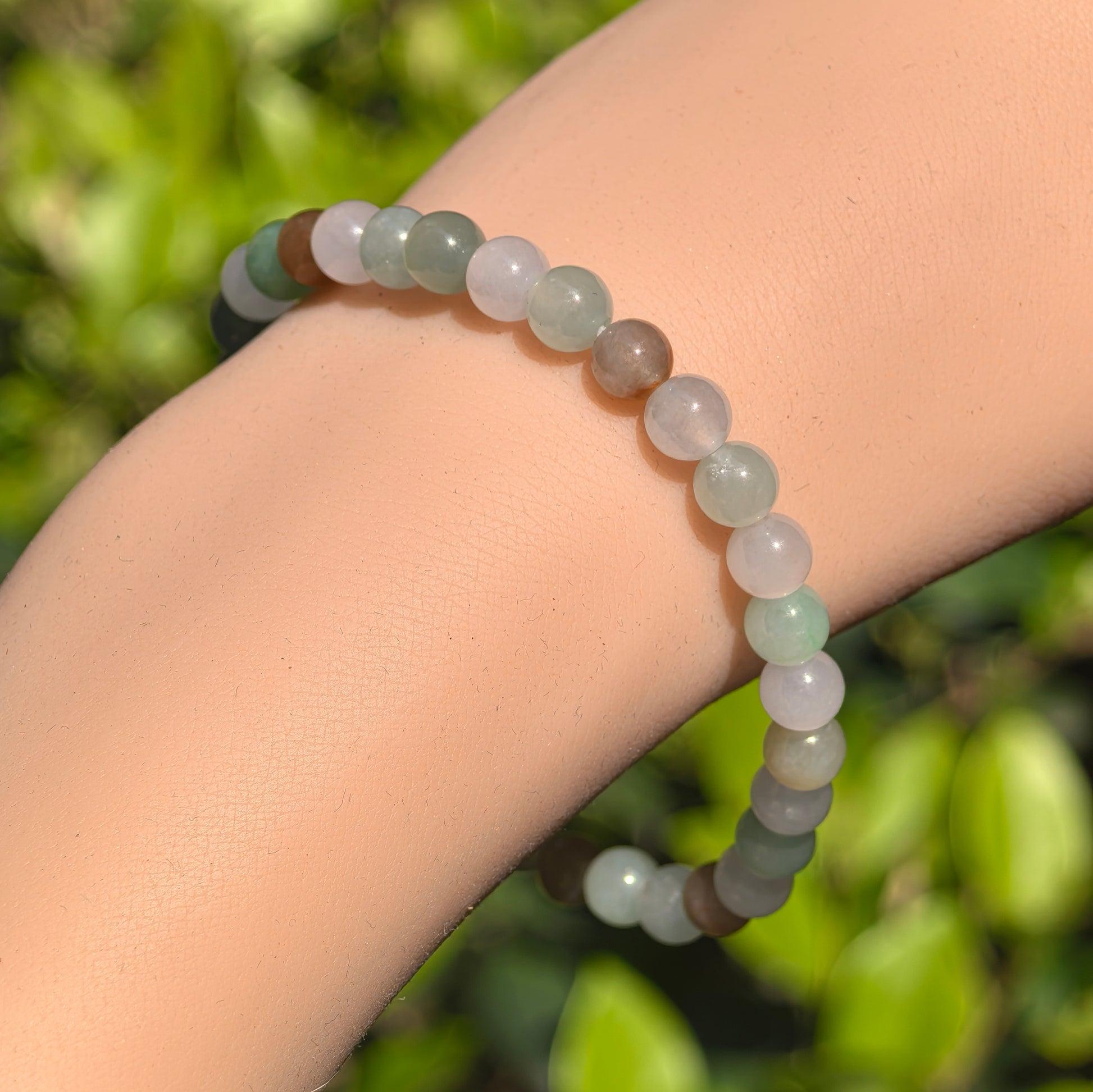Round 32-bead jadeite bracelet showing soft translucent icy glutinous texture.
