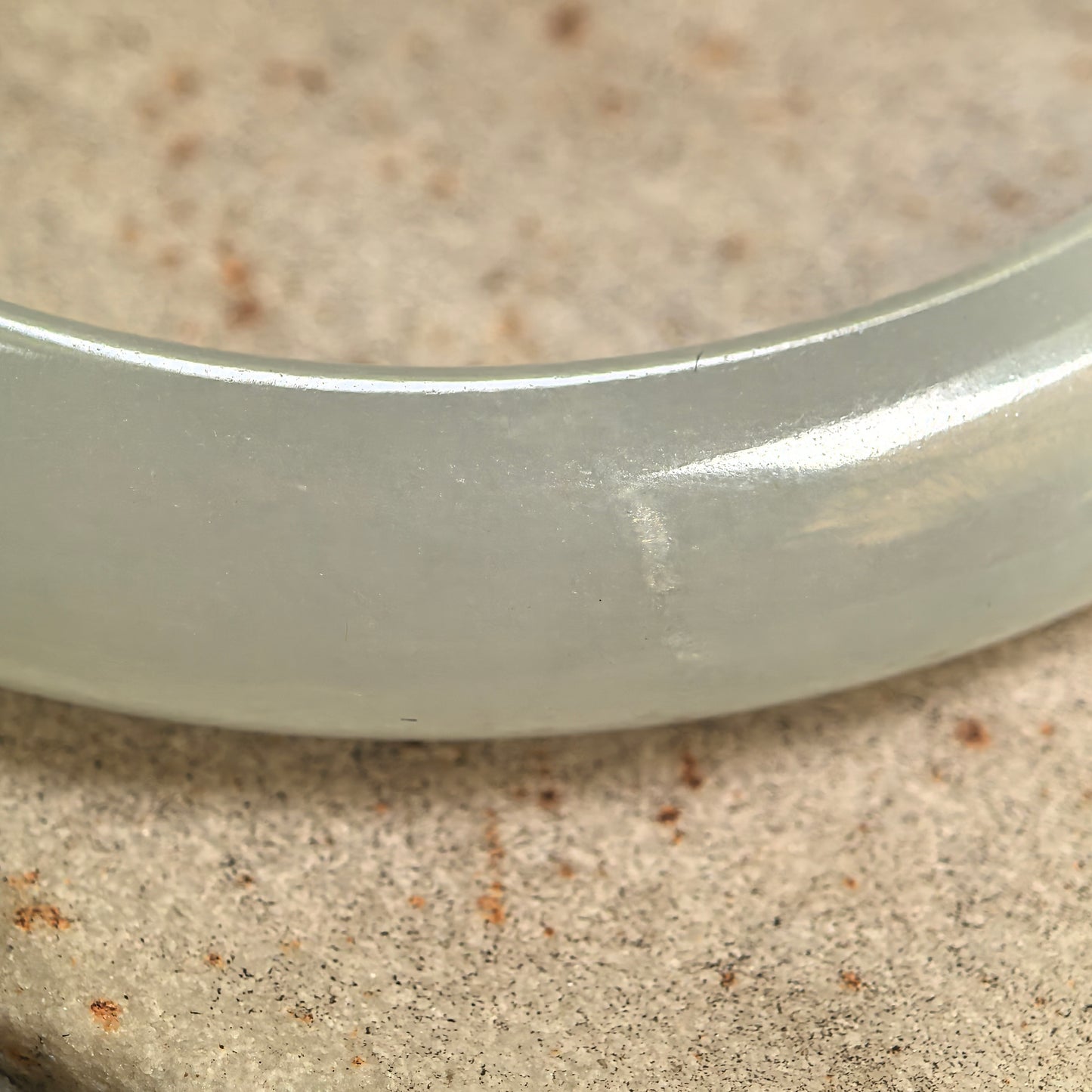 Close-up of jadeite bangle surface showing the crystallization-like texture.
