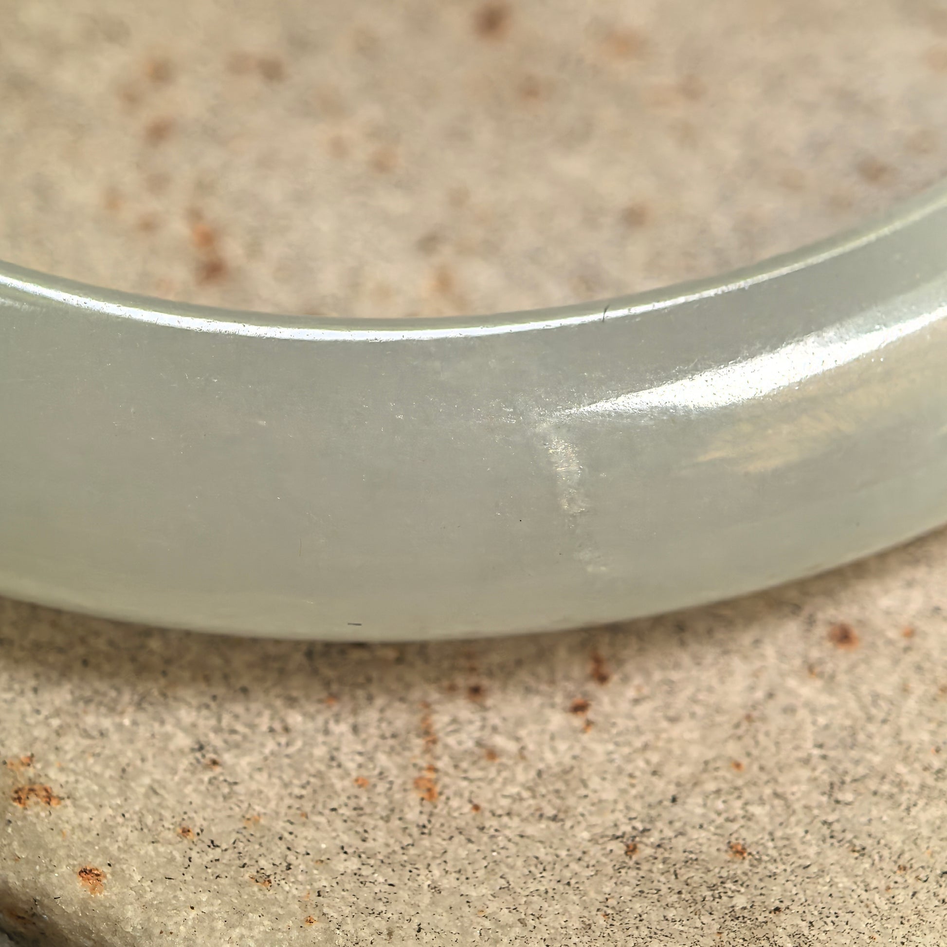 Close-up of jadeite bangle surface showing the crystallization-like texture.
