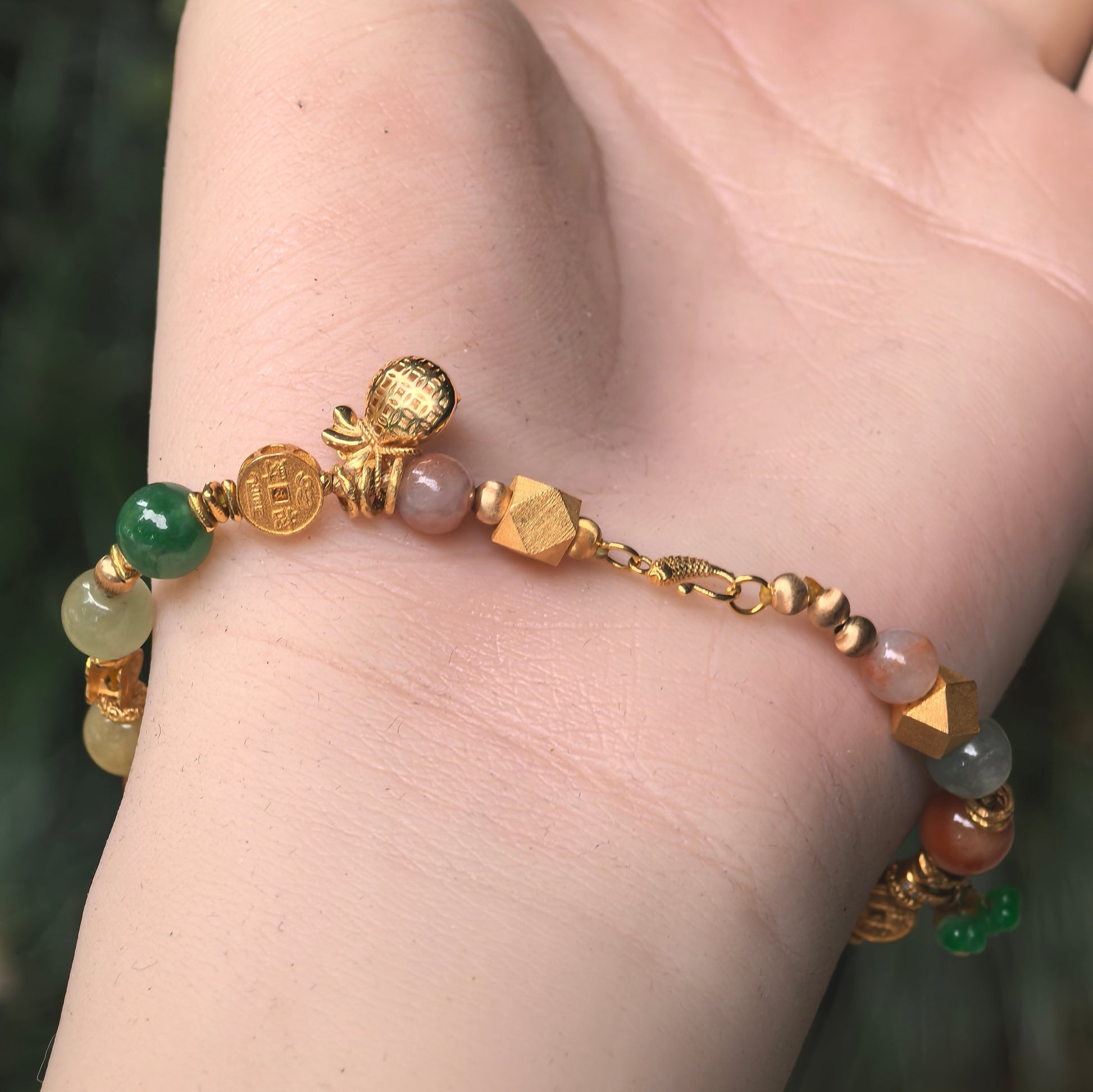 Natural Grade-A glutinous multicolor jadeite bracelet with 18K gold clasp and decorative charm accents.
