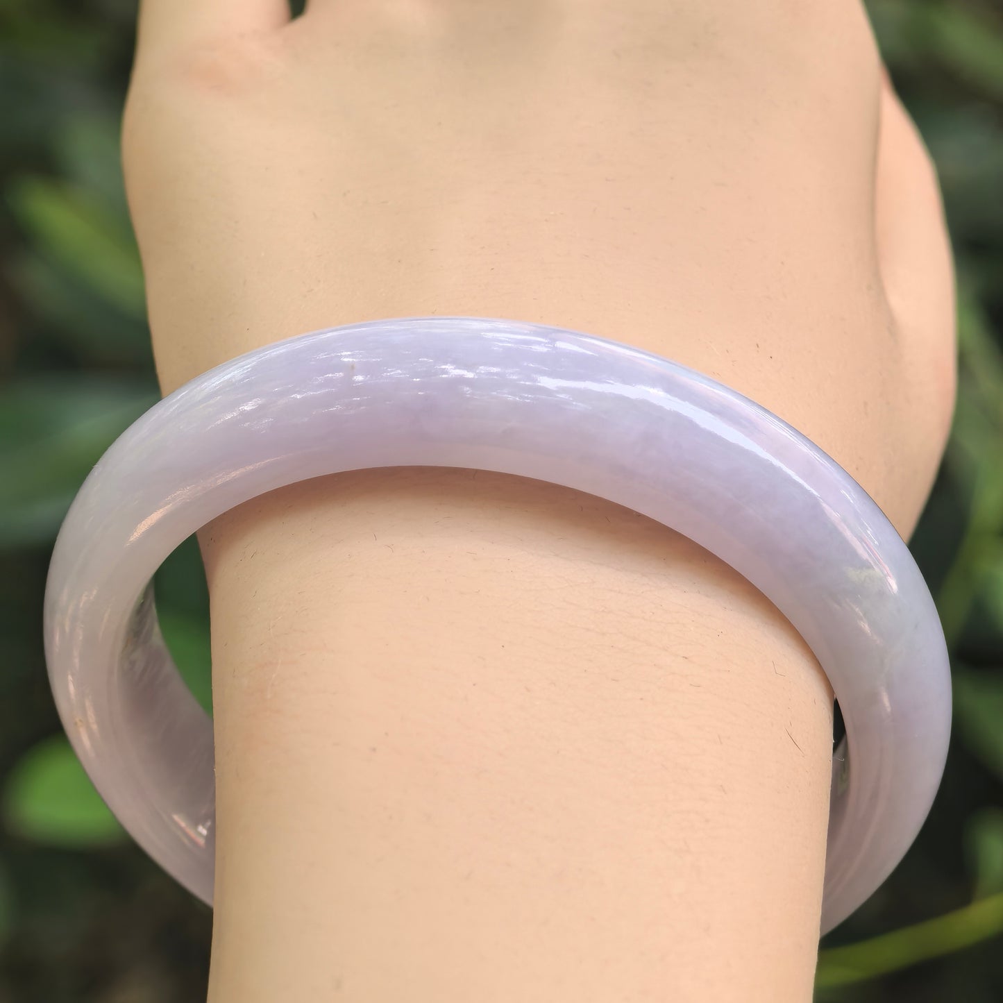 Close-up of light lavender jadeite bangle showing smooth polish and soft glutinous texture.
