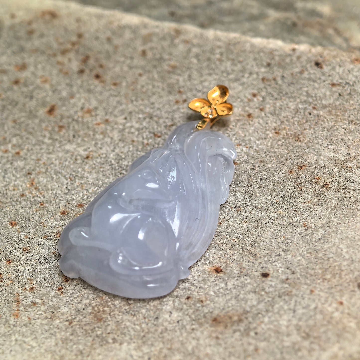 Side view of NGTC certified lavender nine-tailed fox jadeite pendant showing carved tail details and icy glutinous texture.
