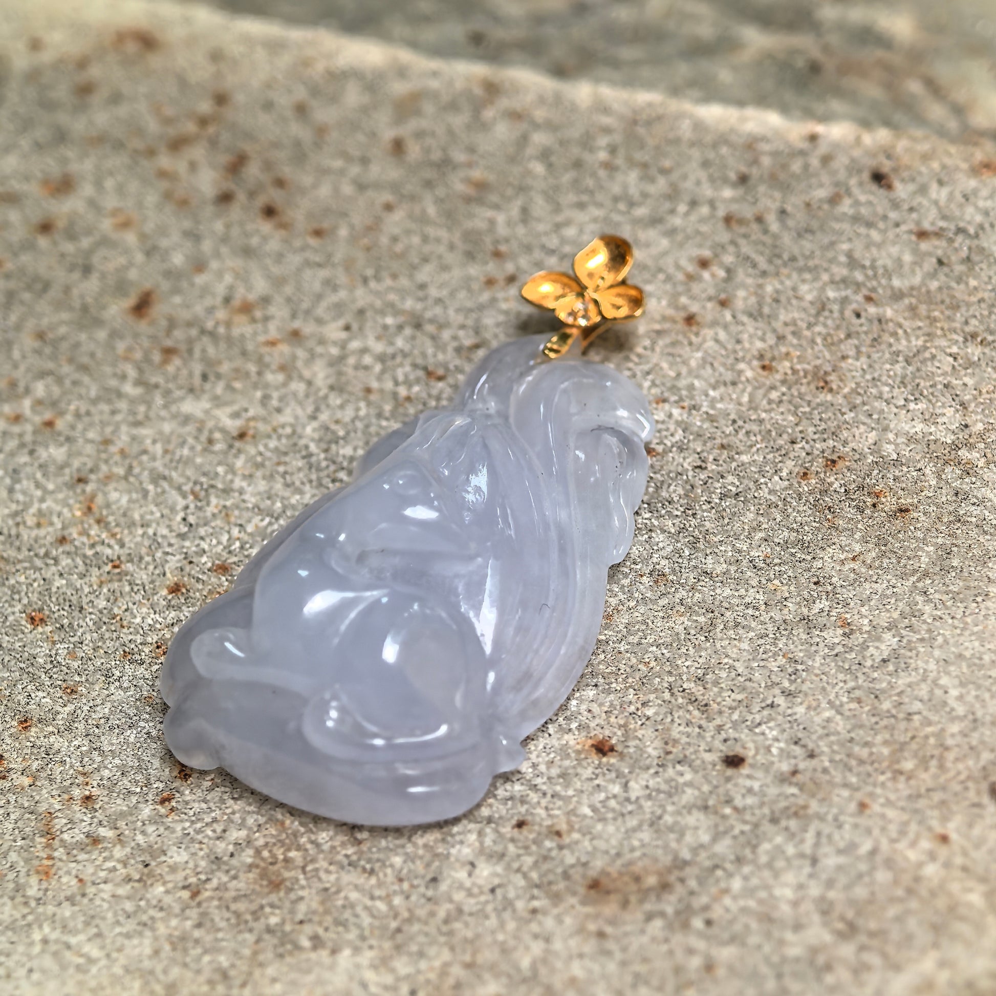 Side view of NGTC certified lavender nine-tailed fox jadeite pendant showing carved tail details and icy glutinous texture.
