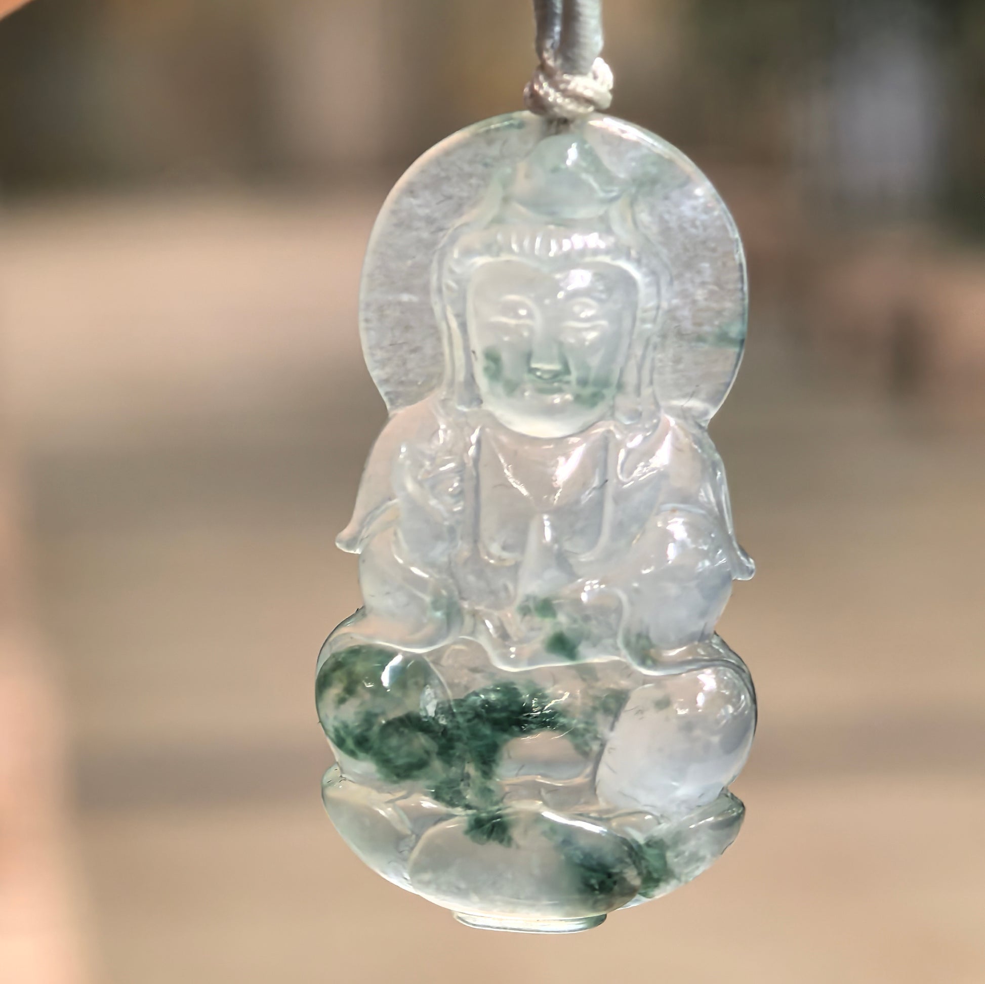 Natural Grade-A icy glutinous light green Guanyin jadeite pendant with floating green flower patterns.
