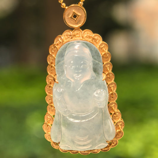 Close-up of white jadeite God of Wealth carving with detailed 18K gold coin-inspired frame.