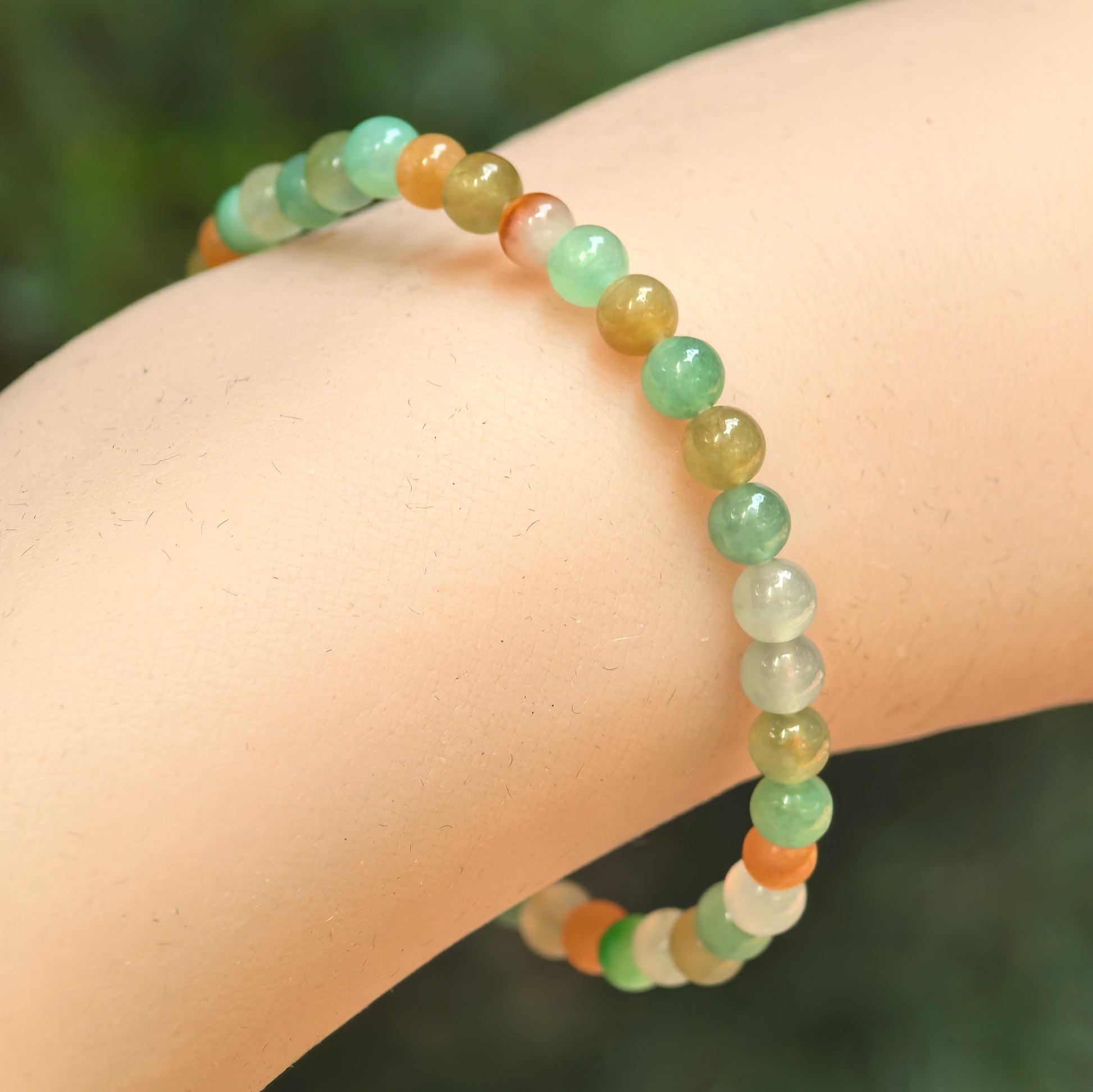 Natural Grade-A glutinous icy multicolor jadeite bead bracelet worn on the wrist.
