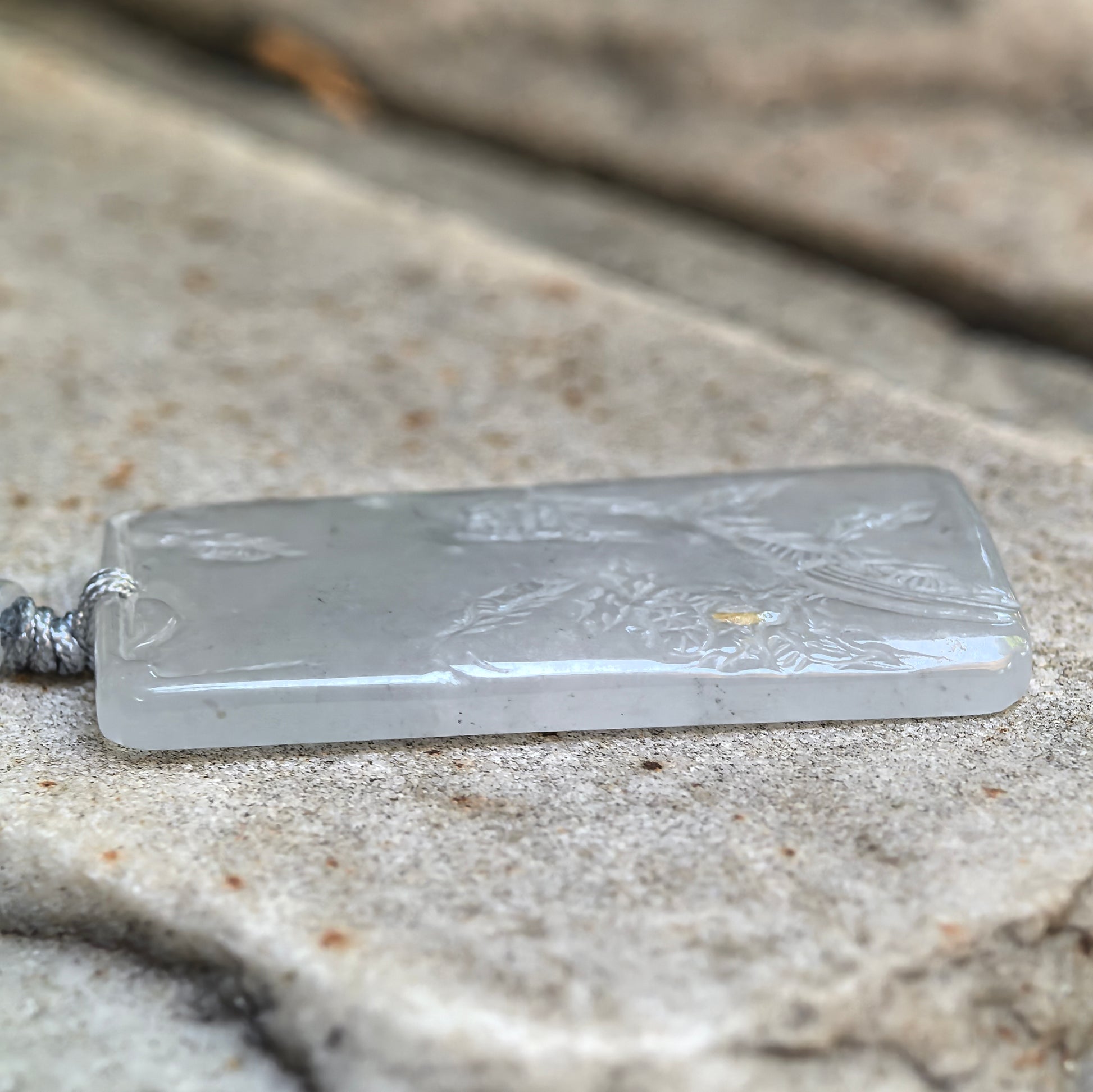 Natural Grade-A white jadeite landscape pendant with subtle grey inclusions and carved scenery.