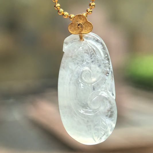 Natural Grade-A Burmese jadeite Ruyi pendant in white and pale green tone under soft light.