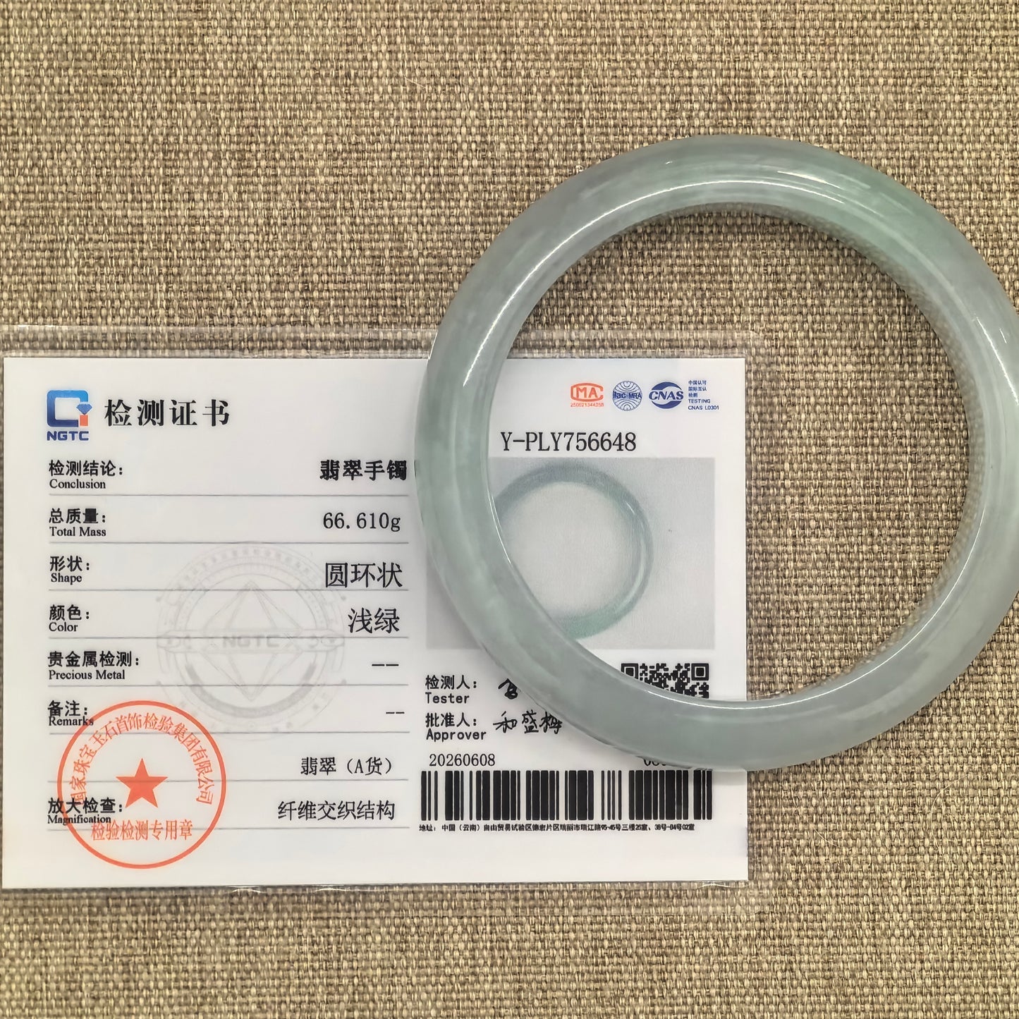 NGTC certified light green jadeite bangle shown with matching certificate and natural fine lines.