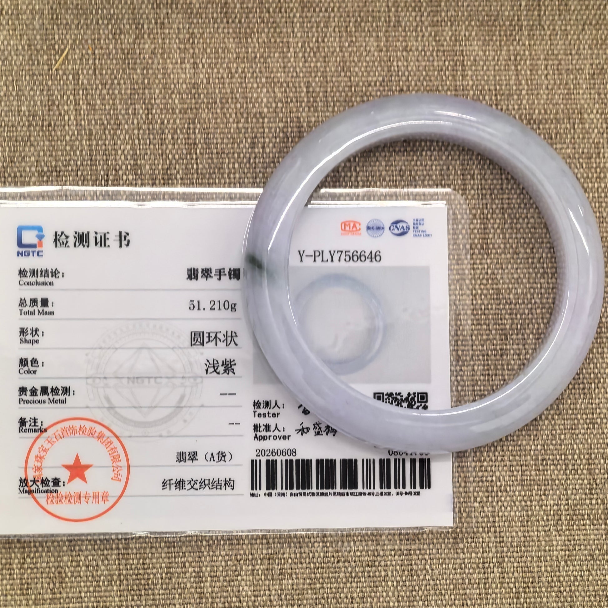 NGTC certified glutinous pale lavender jadeite bangle displayed with matching certificate.