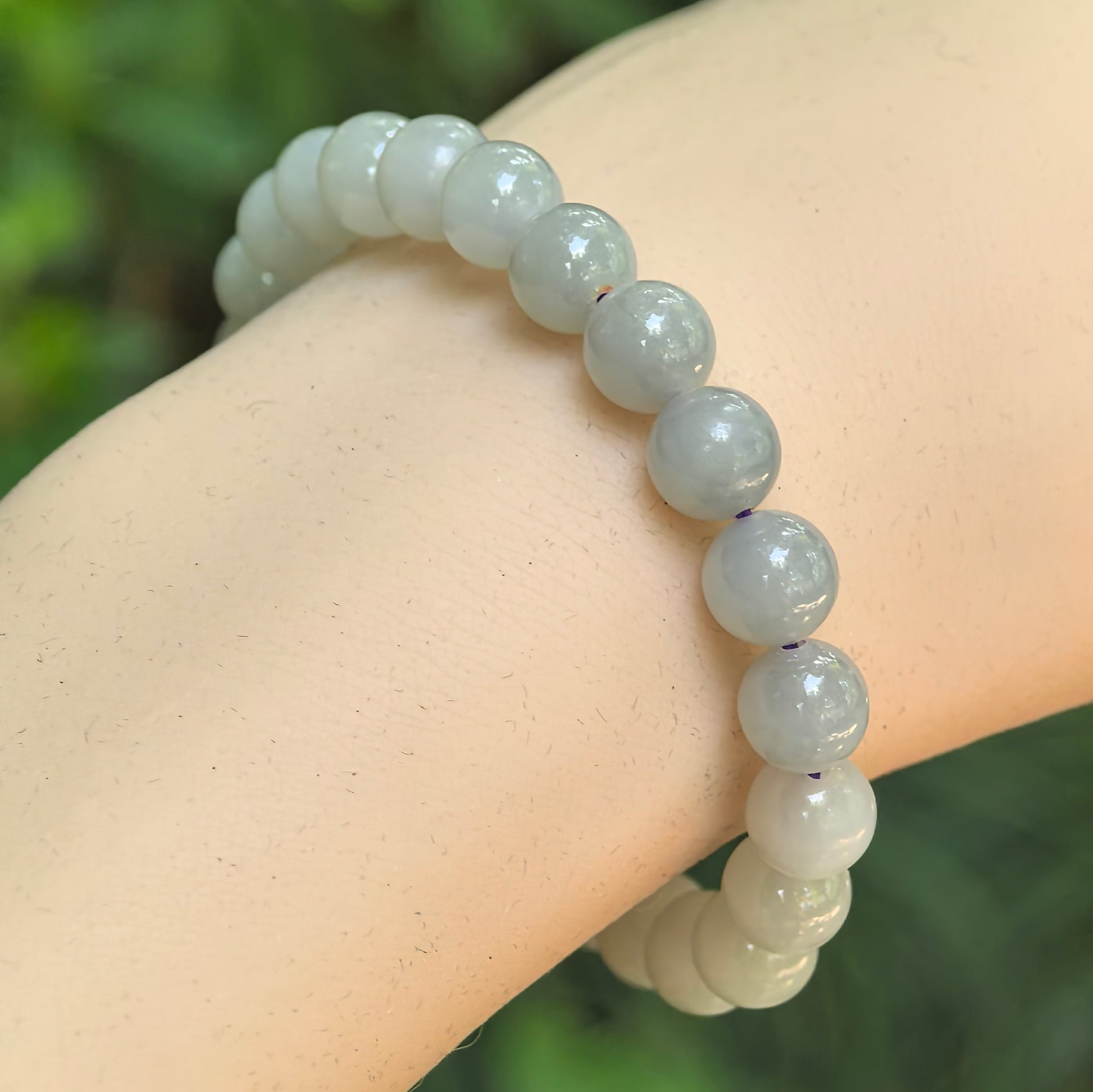 Natural gray-purple Hetian jade 8mm bead bracelet worn on wrist.