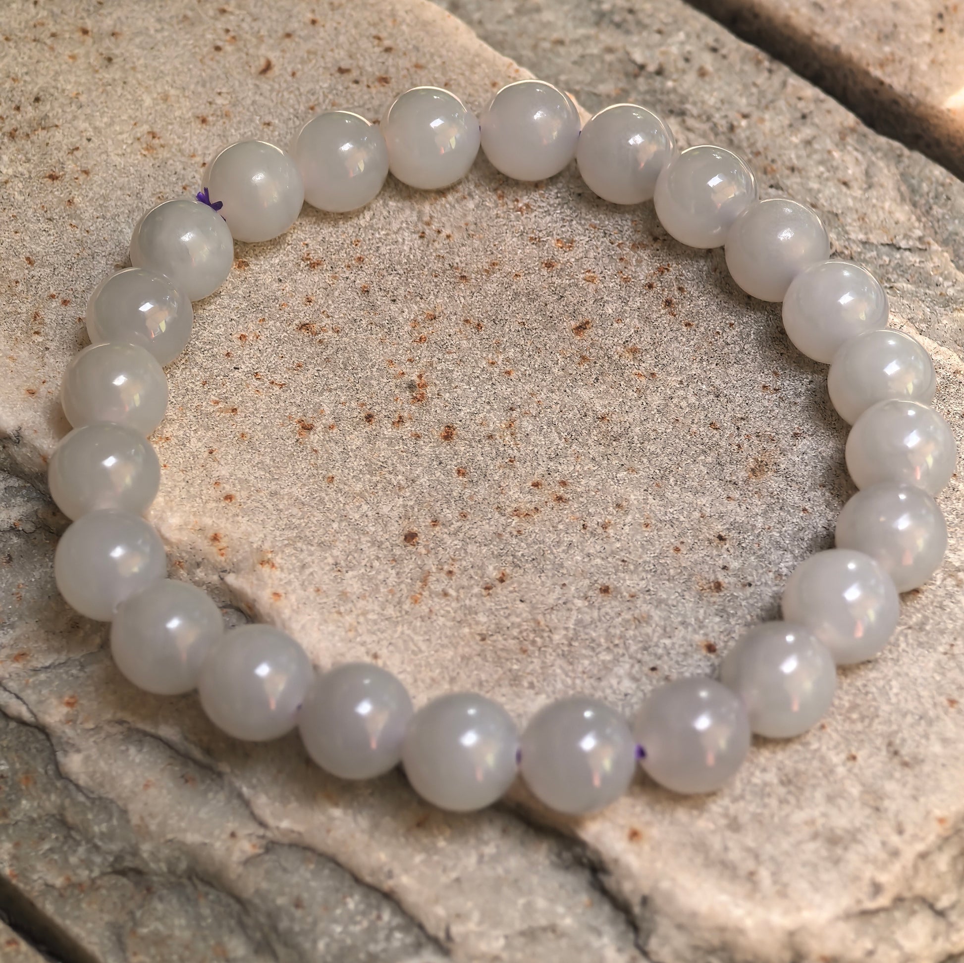 Gray-purple nephrite elastic bead bracelet showing visible natural water lines.