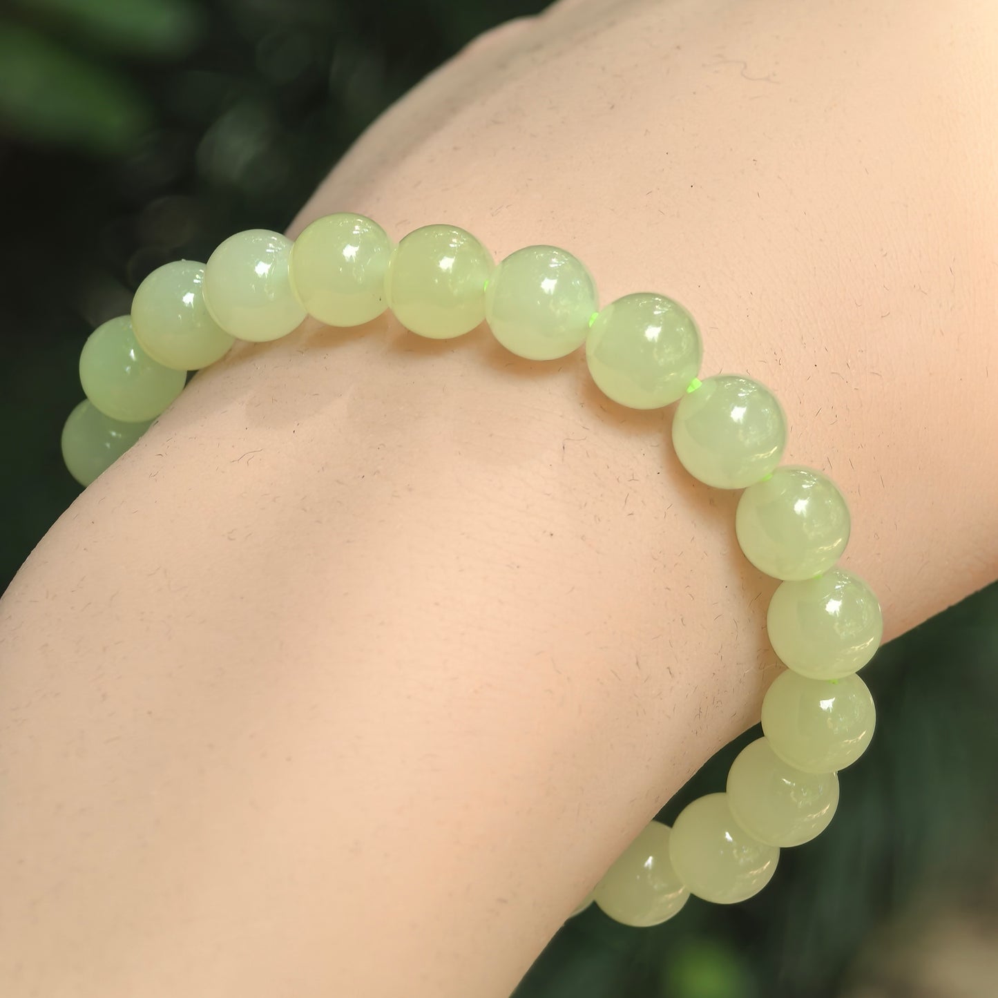Natural yellow Hetian jade 8mm bead bracelet worn on wrist.